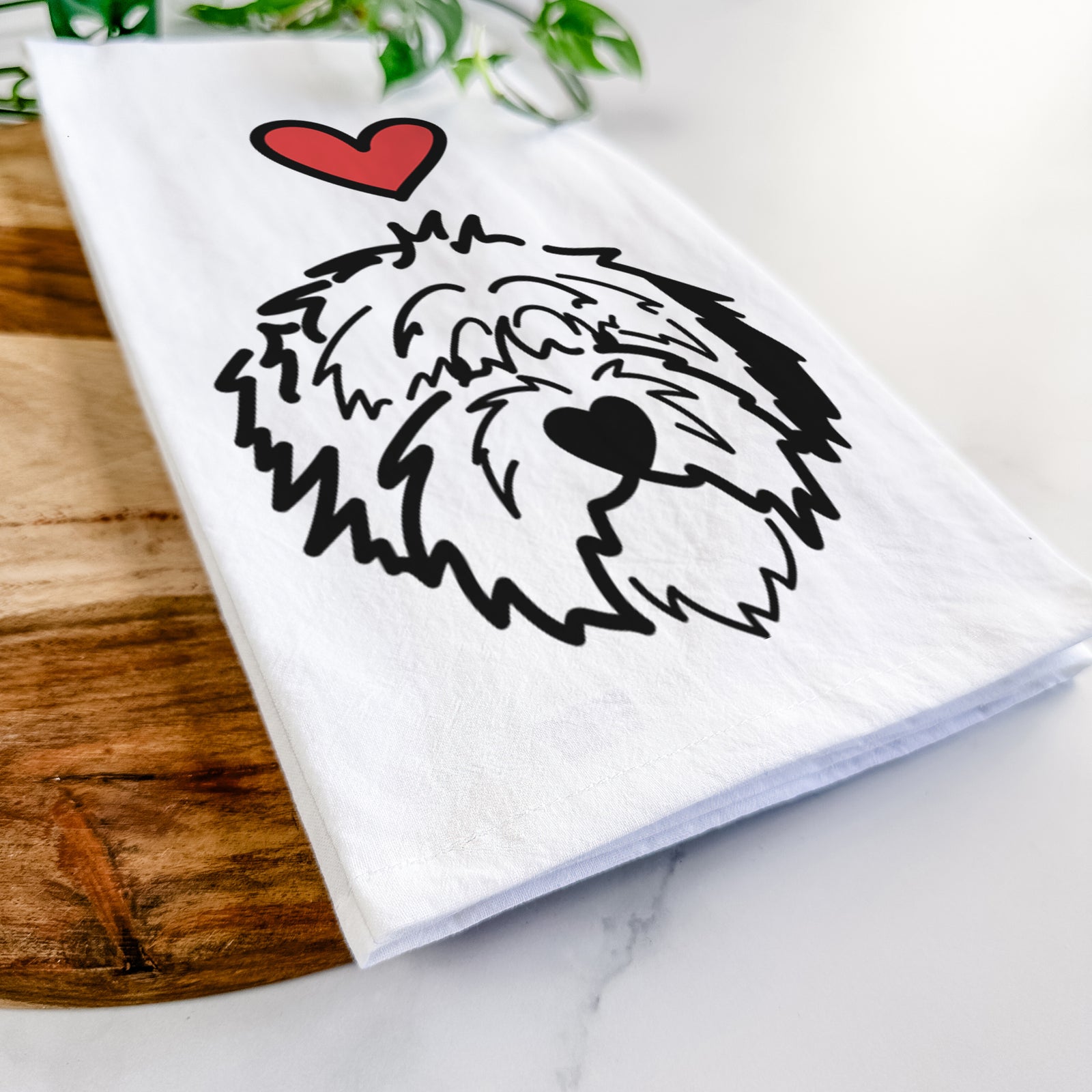 Minimalist line drawing of Penny the Old English Sheepdog with a red heart on a tea towel
