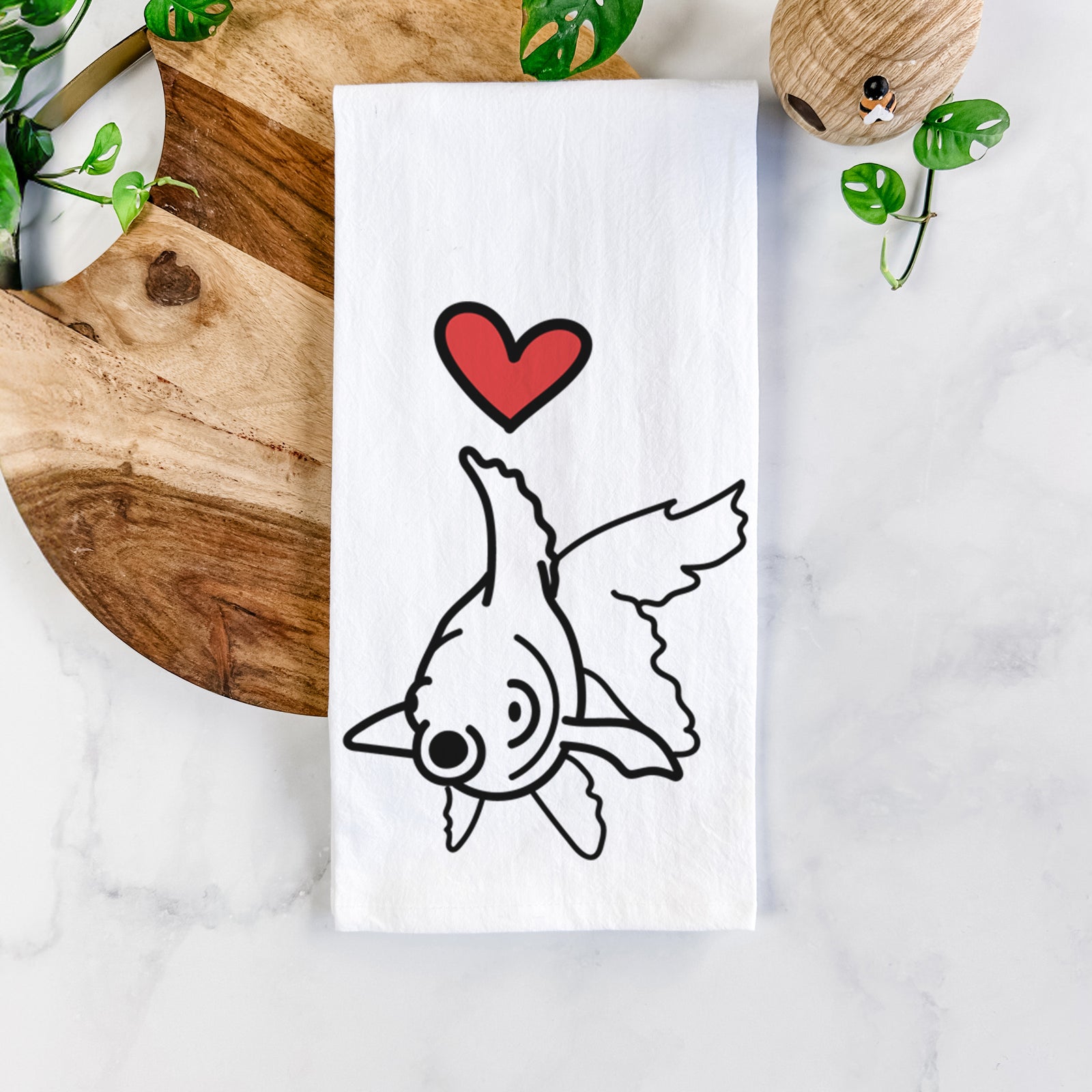Minimalist line drawing of Ruby the Goldfish with a red heart on a tea towel