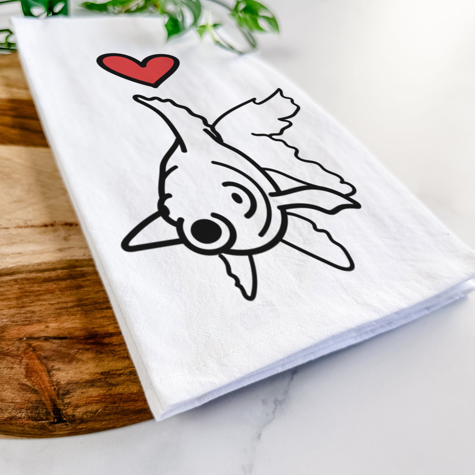 Minimalist line drawing of Ruby the Goldfish with a red heart on a tea towel
