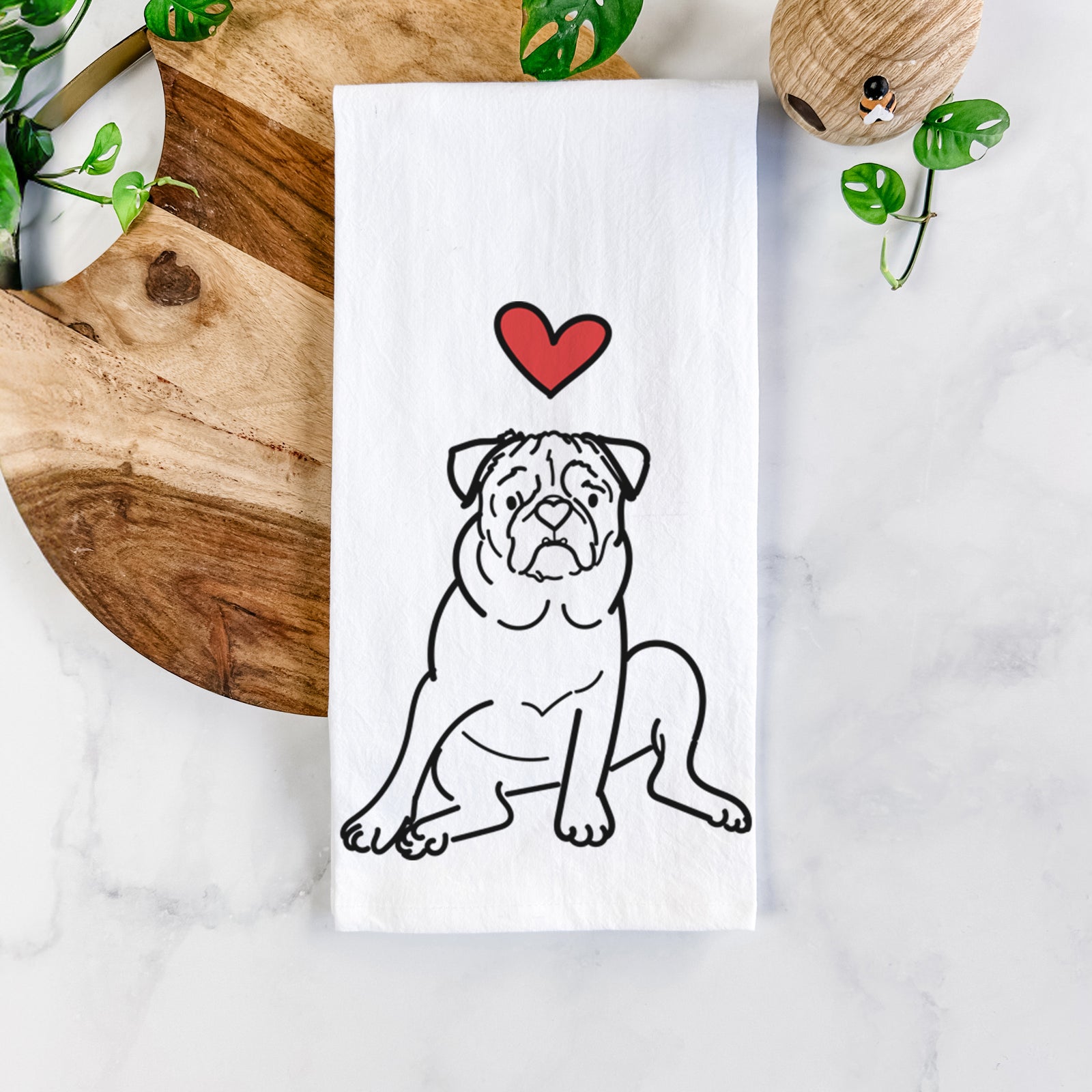 Minimalist line drawing of Rudy the Pug with a red heart on a tea towel