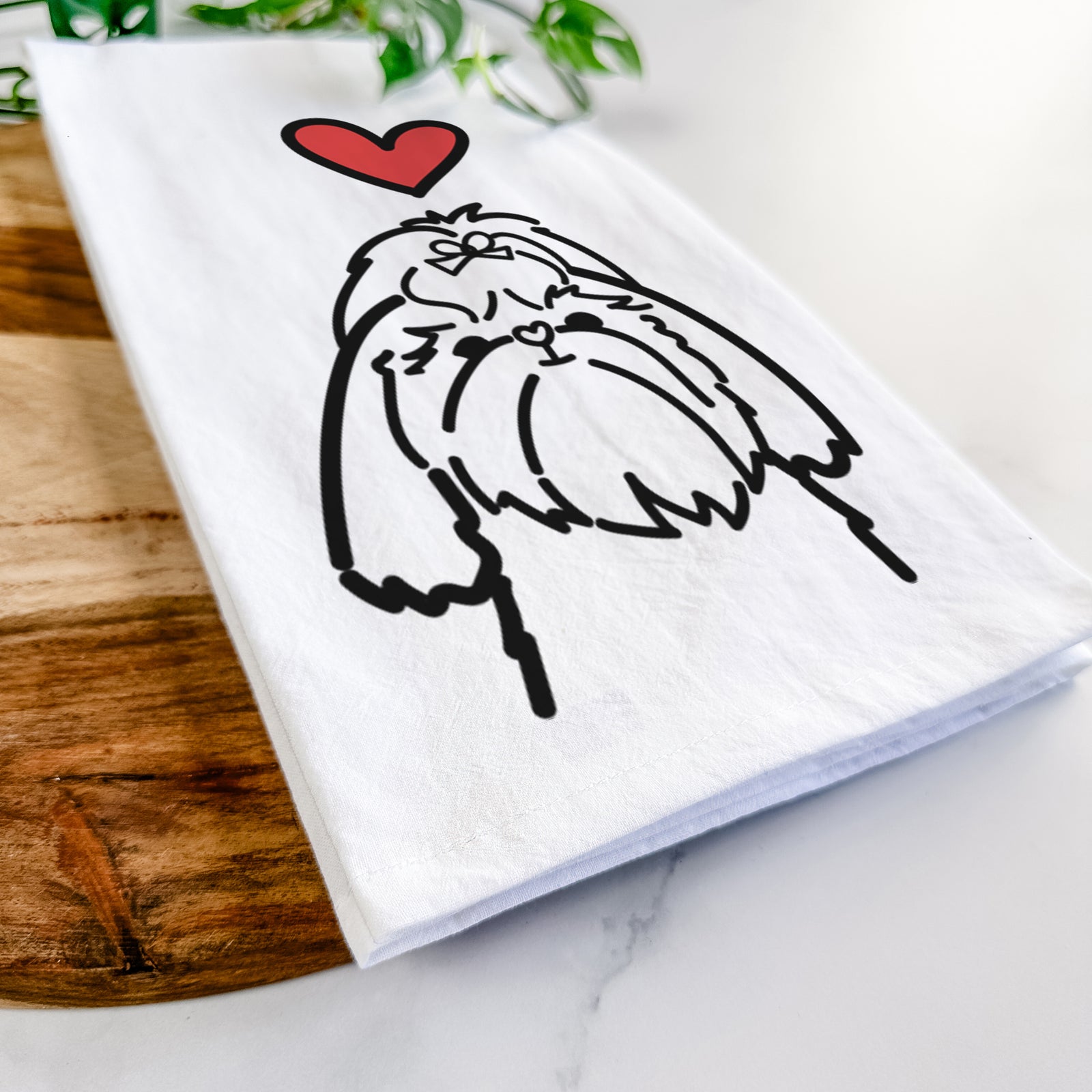 Minimalist line drawing of a Shih Tzu with a red heart on a tea towel