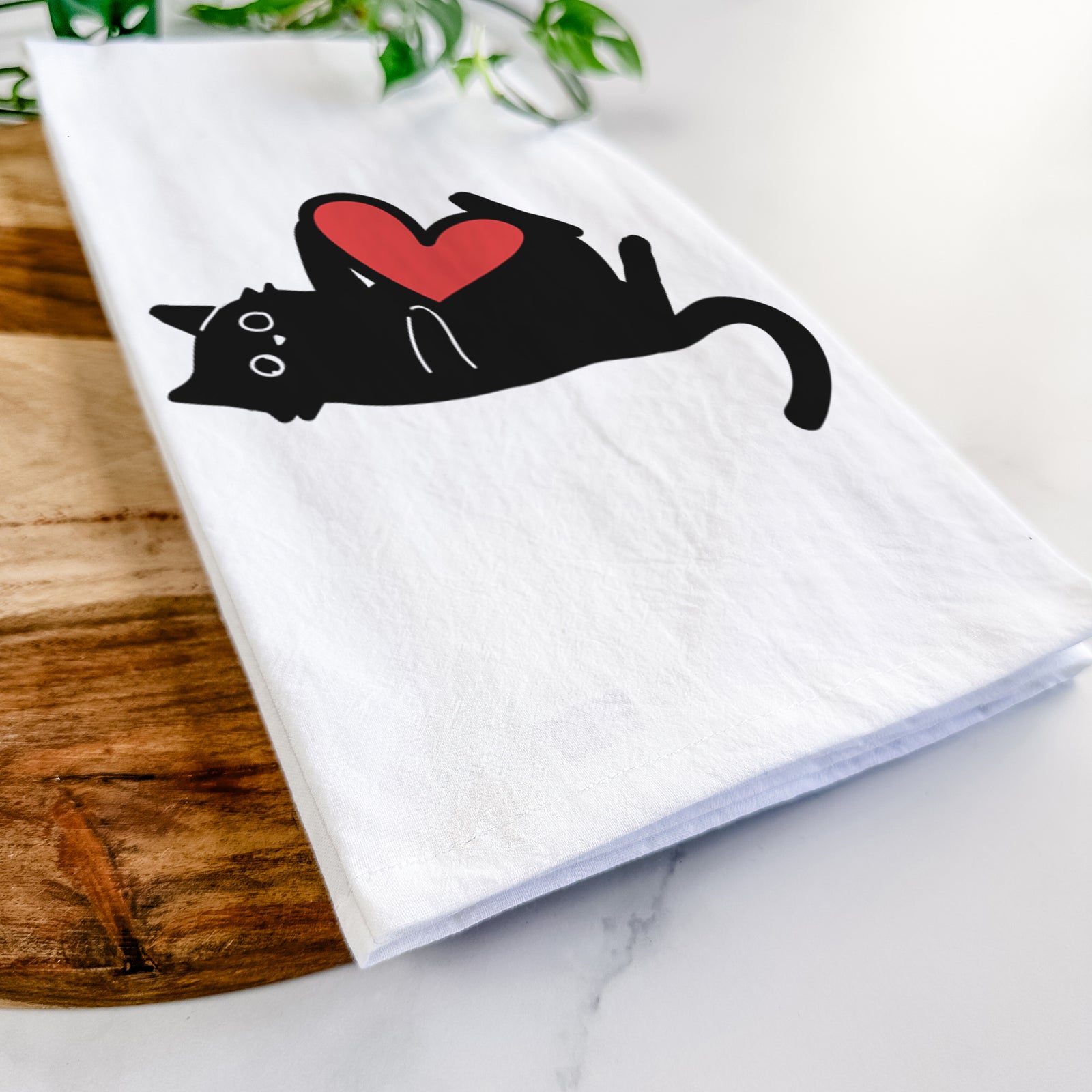 Minimalist line drawing of Smash the Black Cat with a red heart on a tea towel