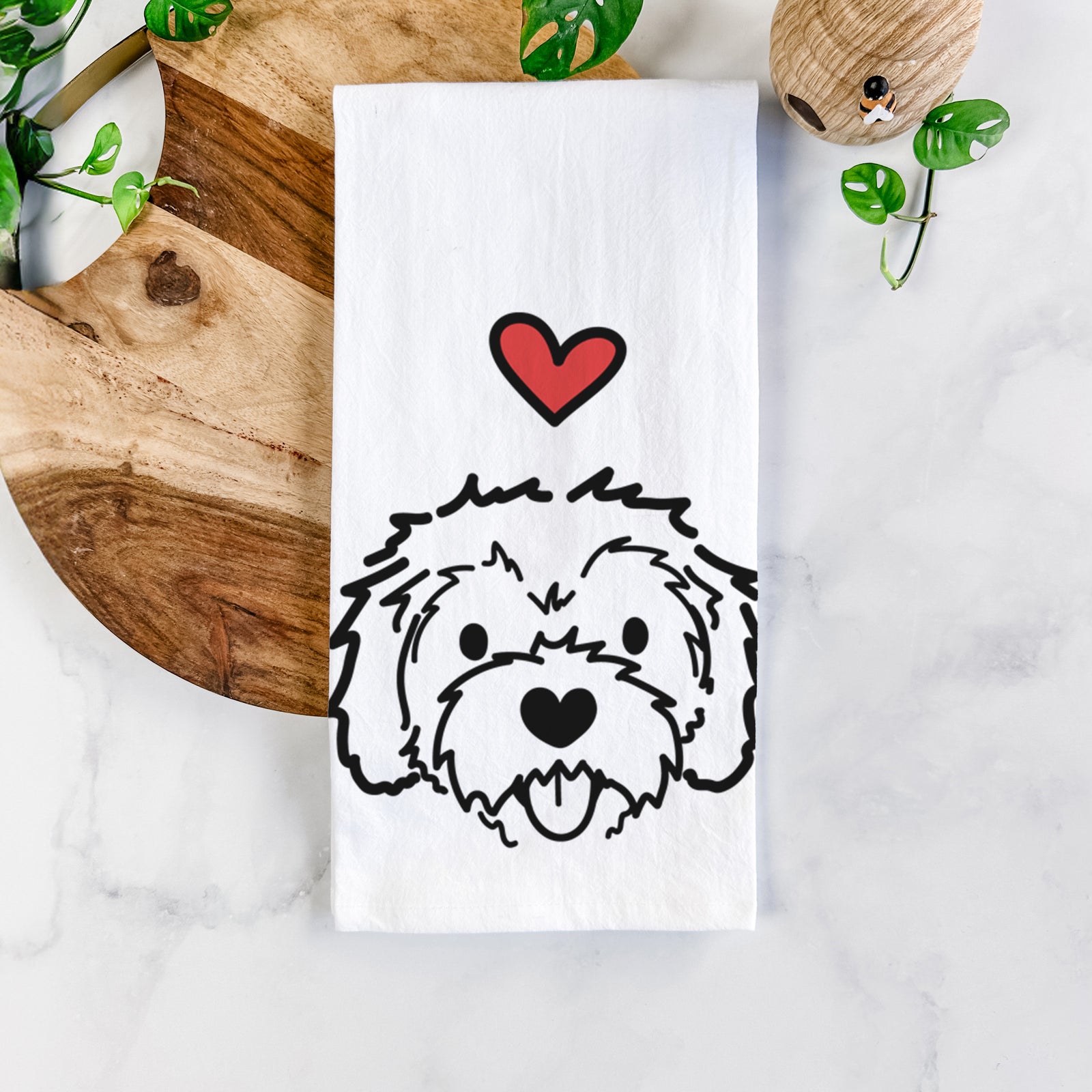 Minimalist line drawing of Sprinkles the Cockapoo with a red heart on a tea towel
