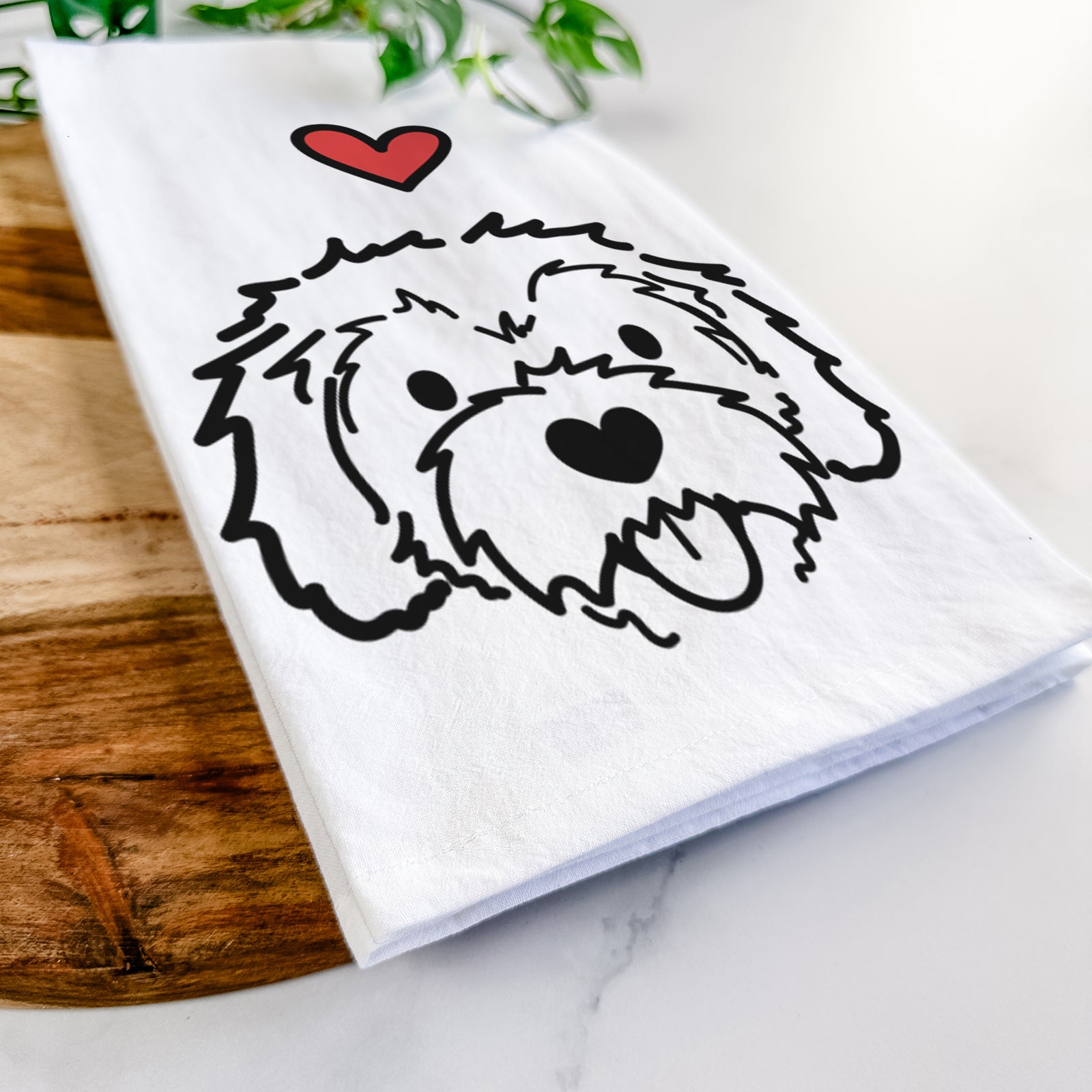 Minimalist line drawing of Sprinkles the Cockapoo with a red heart on a tea towel