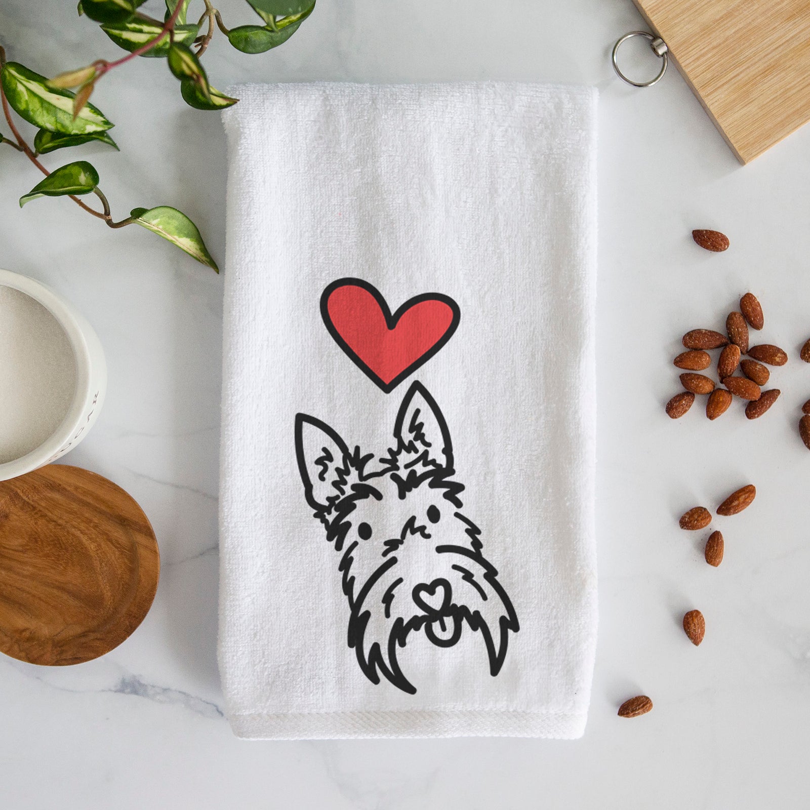 Minimalist line drawing of Thistle the Scottish Terrier with a red heart on a decorative hand towel