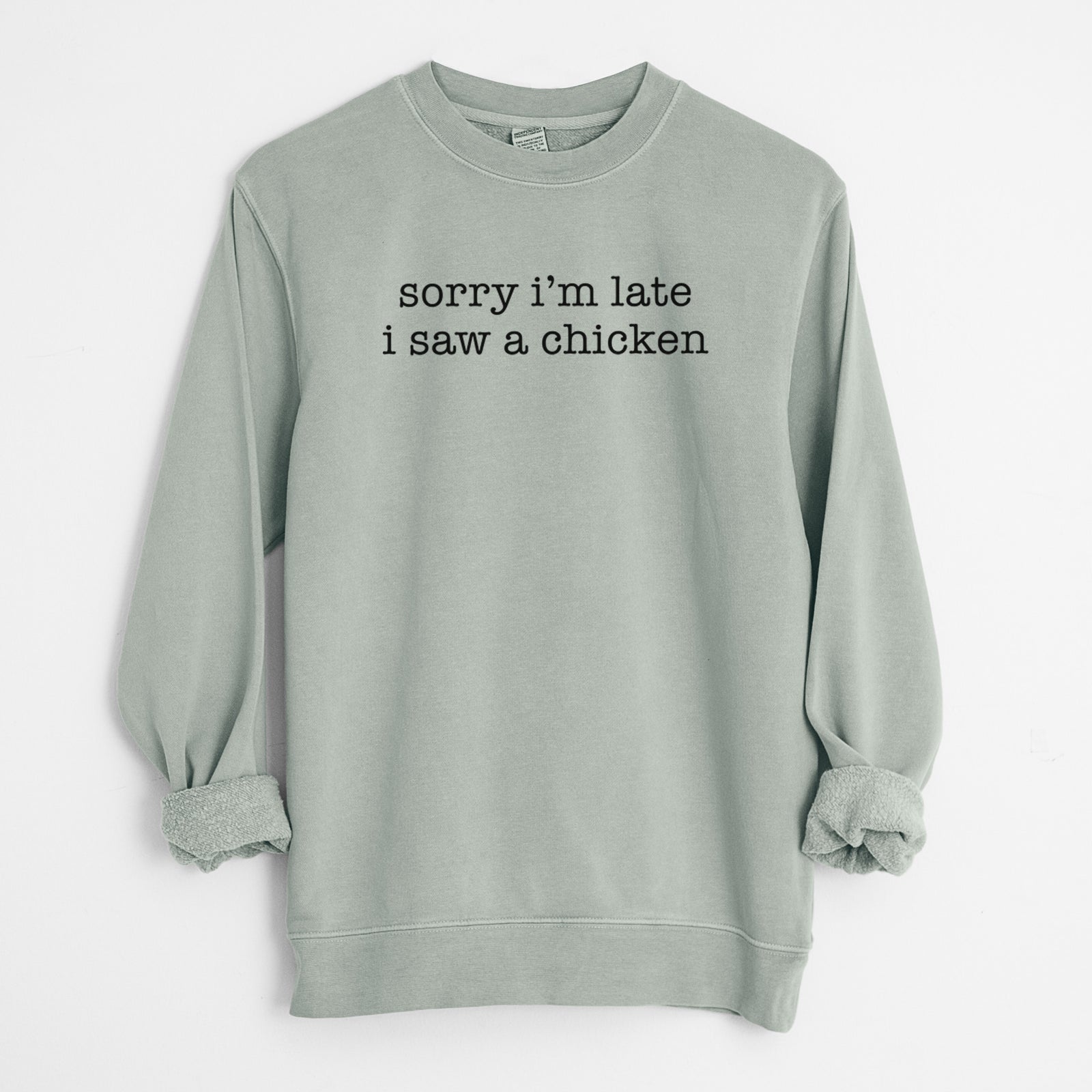 'Sorry I'm Late I Saw a Chicken' design on a Sage Unisex pigment dyed crew sweatshirt
