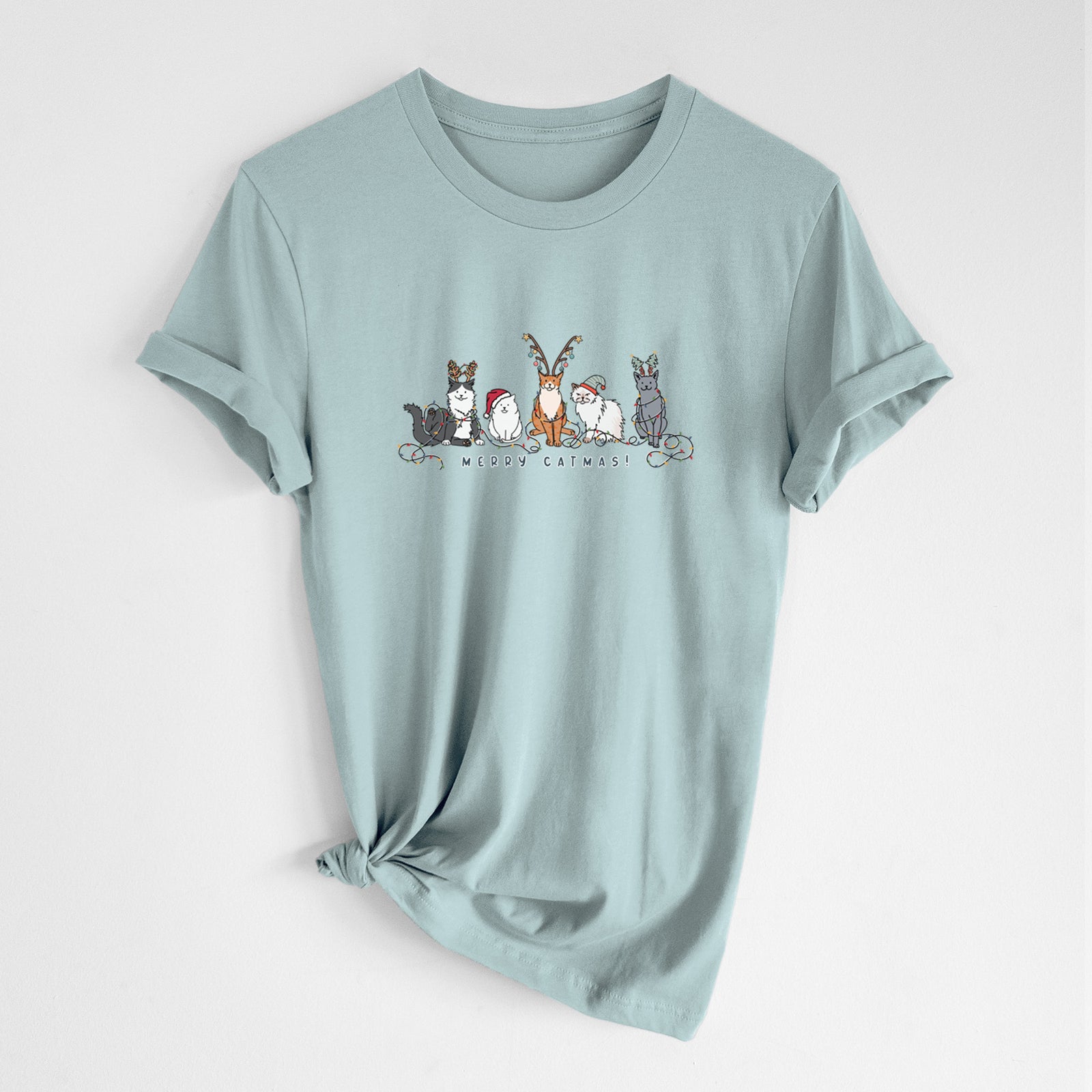 'Merry Catmas' design on a Dusty Blue Unisex crewneck, worn by a woman