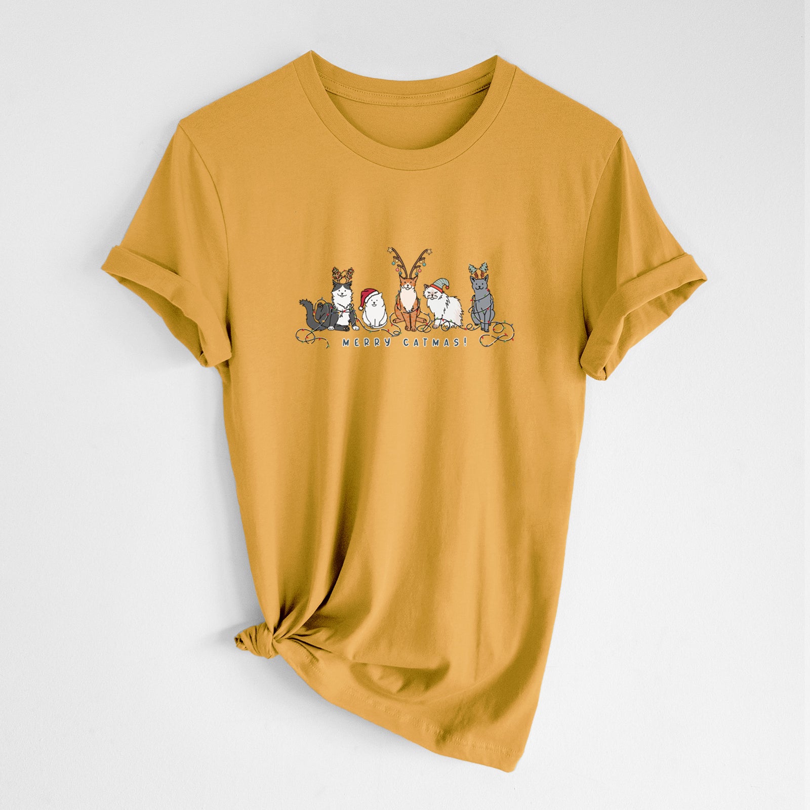 'Merry Catmas' design on a Mustard Unisex crewneck, worn by a woman