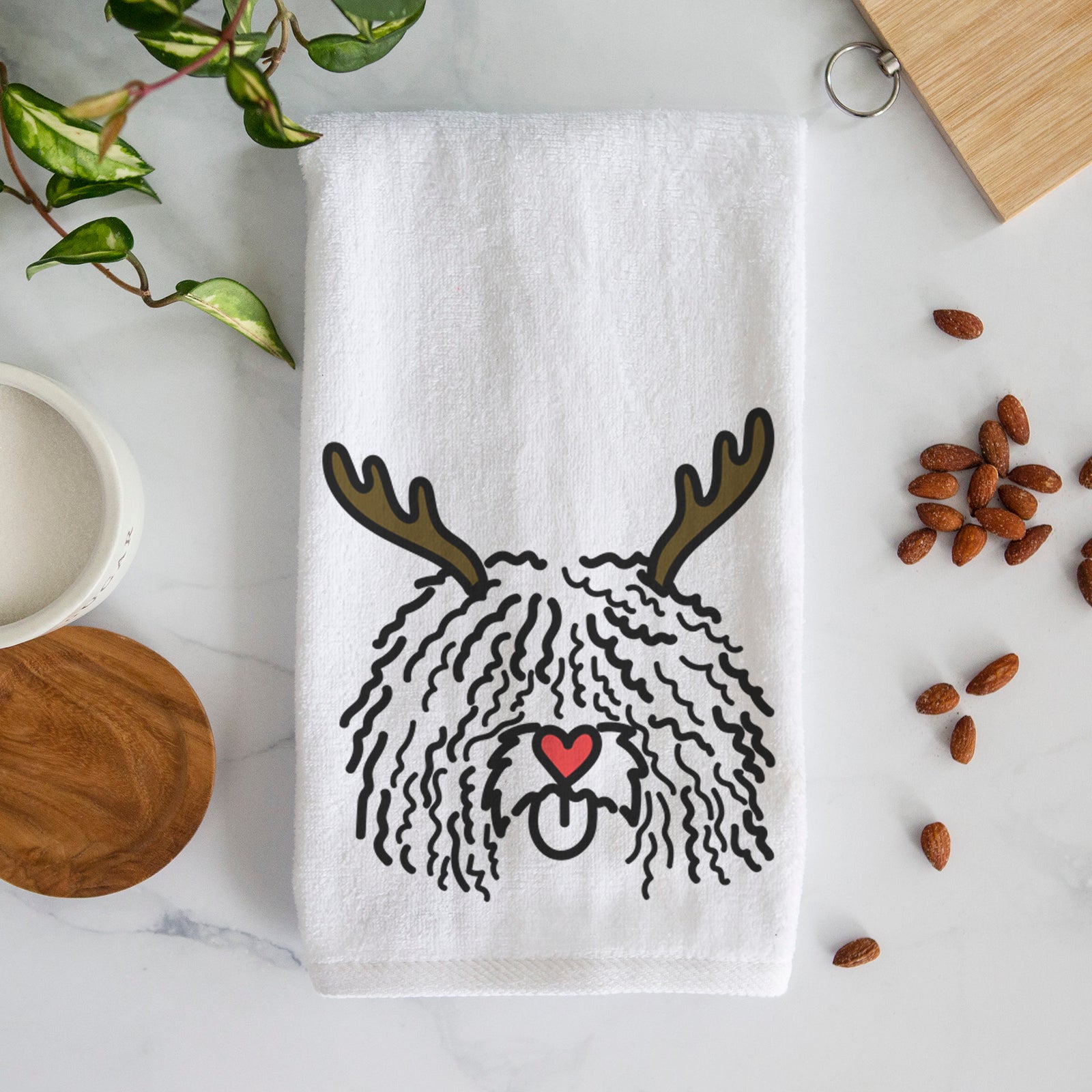 Minimalist line drawing of Alba the Spanish Water Dog with reindeer antlers and a red nose on a decorative hand towel