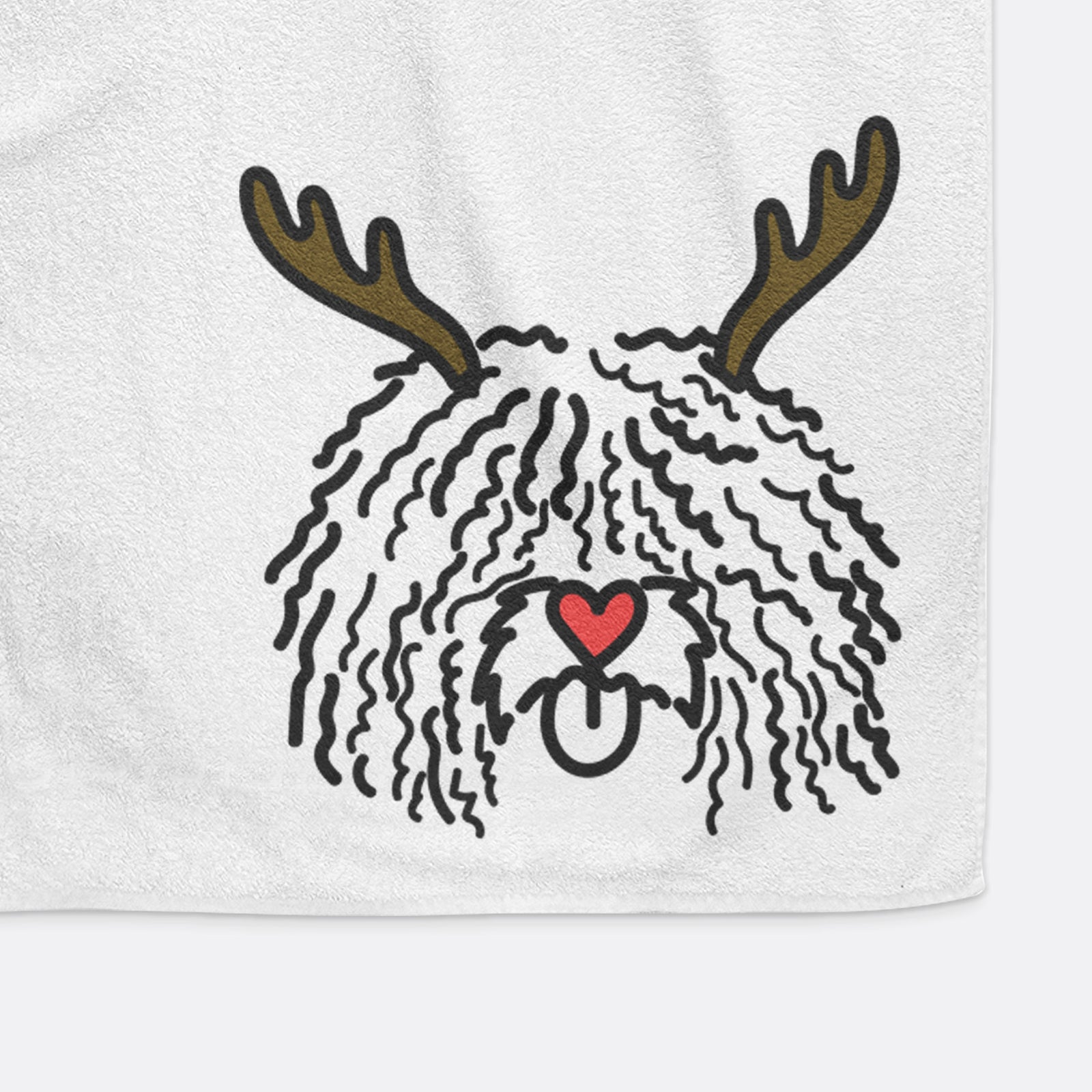 Minimalist line drawing of Alba the Spanish Water Dog with reindeer antlers and a red nose on a decorative hand towel