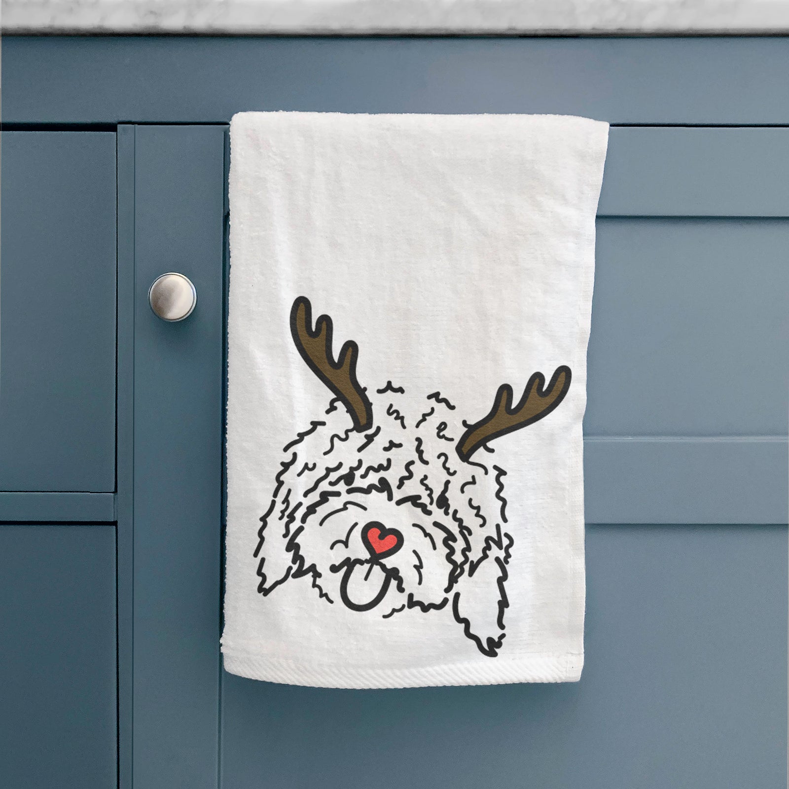 Minimalist line drawing of Antonio the Spanish Water Dog with reindeer antlers and a red nose on a decorative hand towel