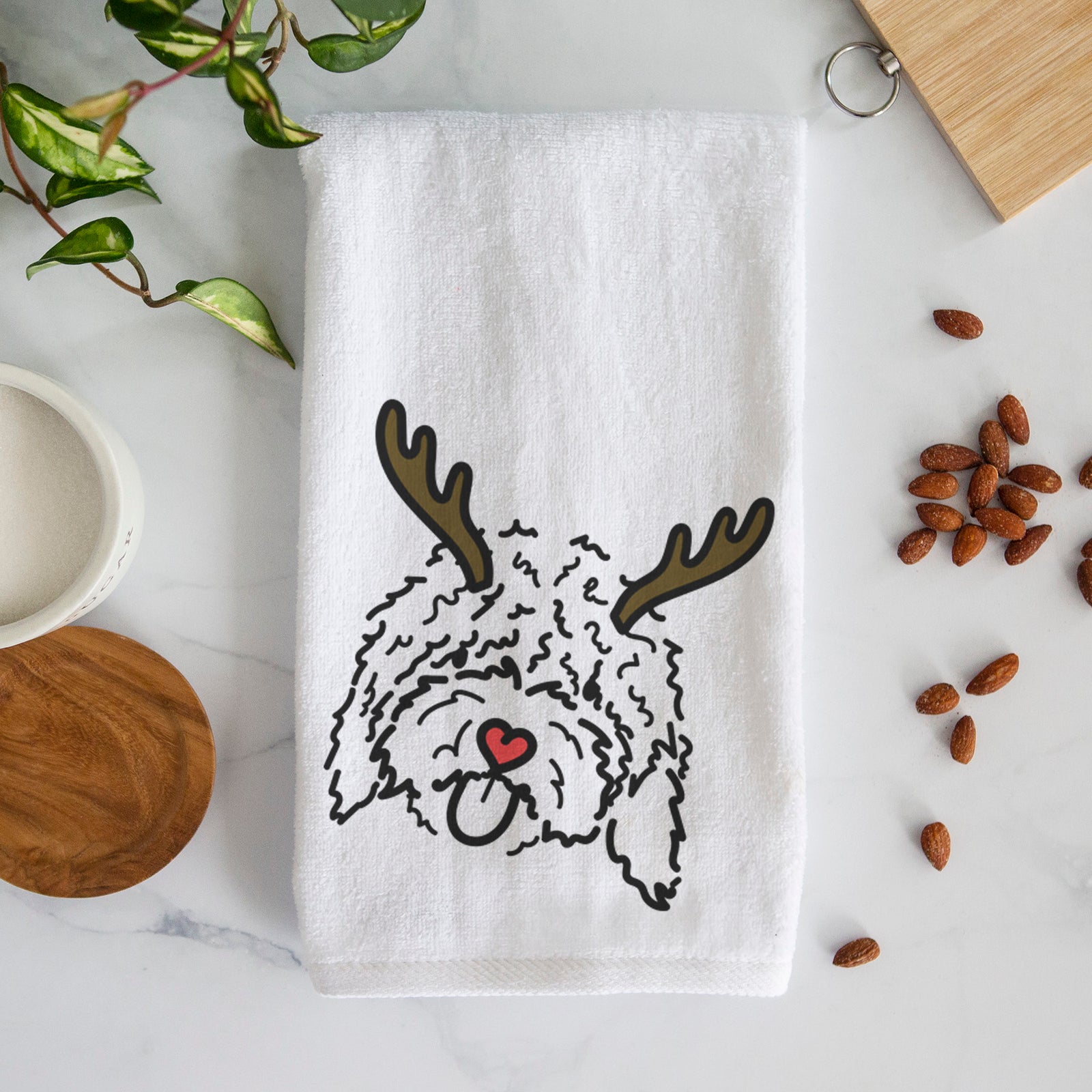 Minimalist line drawing of Antonio the Spanish Water Dog with reindeer antlers and a red nose on a decorative hand towel