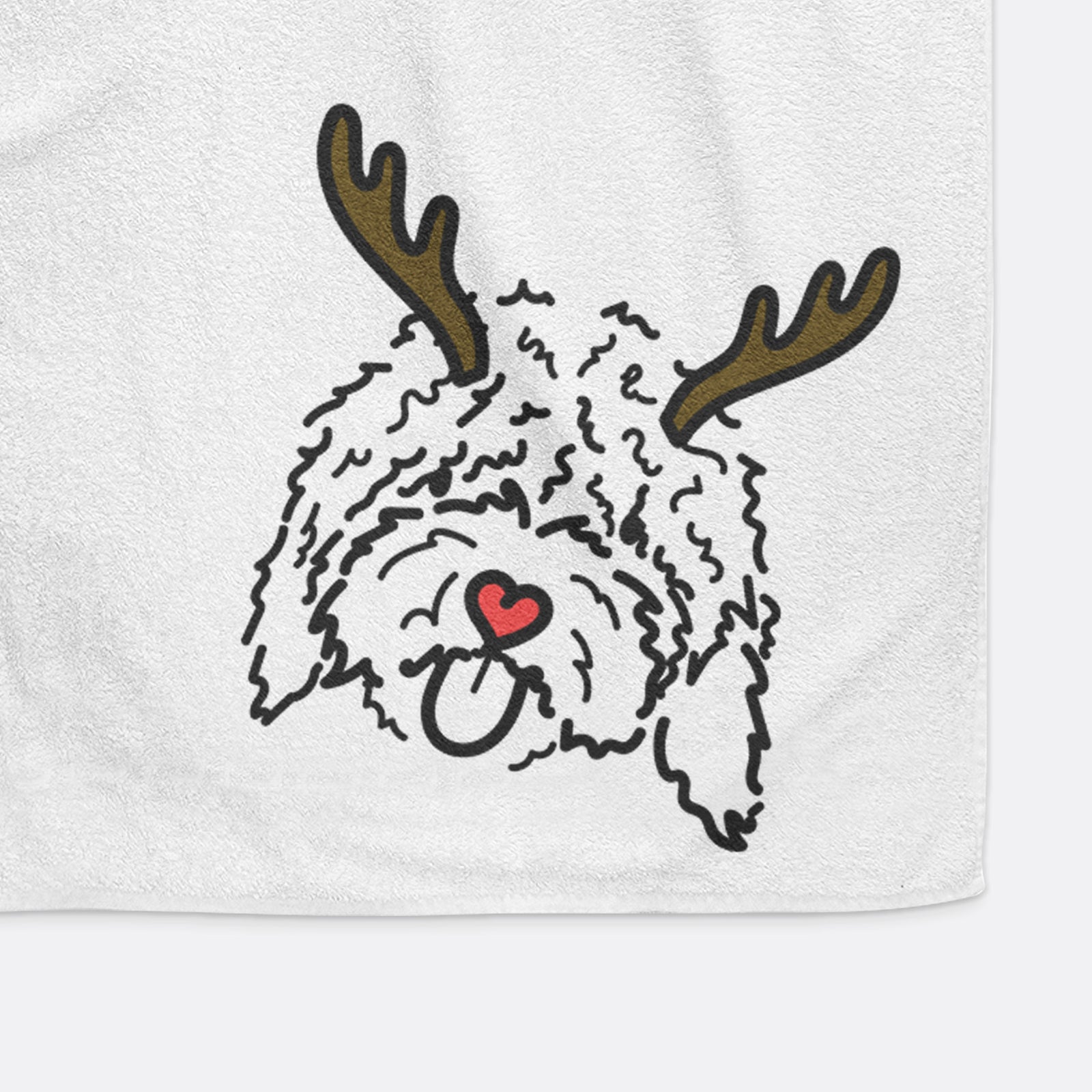 Minimalist line drawing of Antonio the Spanish Water Dog with reindeer antlers and a red nose on a decorative hand towel