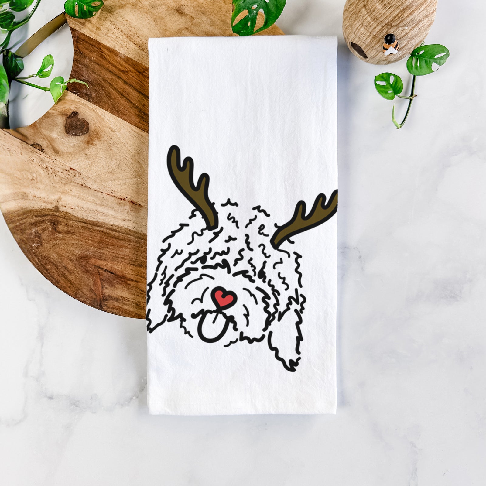 Minimalist line drawing of Antonio the Spanish Water Dog with reindeer antlers and a red nose on a tea towel