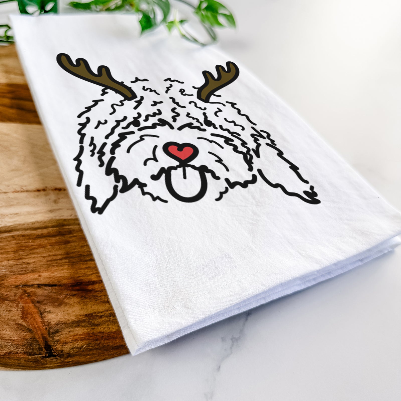 Minimalist line drawing of Antonio the Spanish Water Dog with reindeer antlers and a red nose on a tea towel