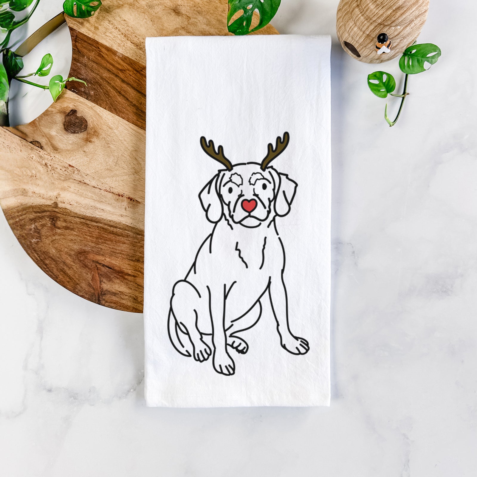 Minimalist line drawing of Babs the Puggle with reindeer antlers and a red nose on a tea towel