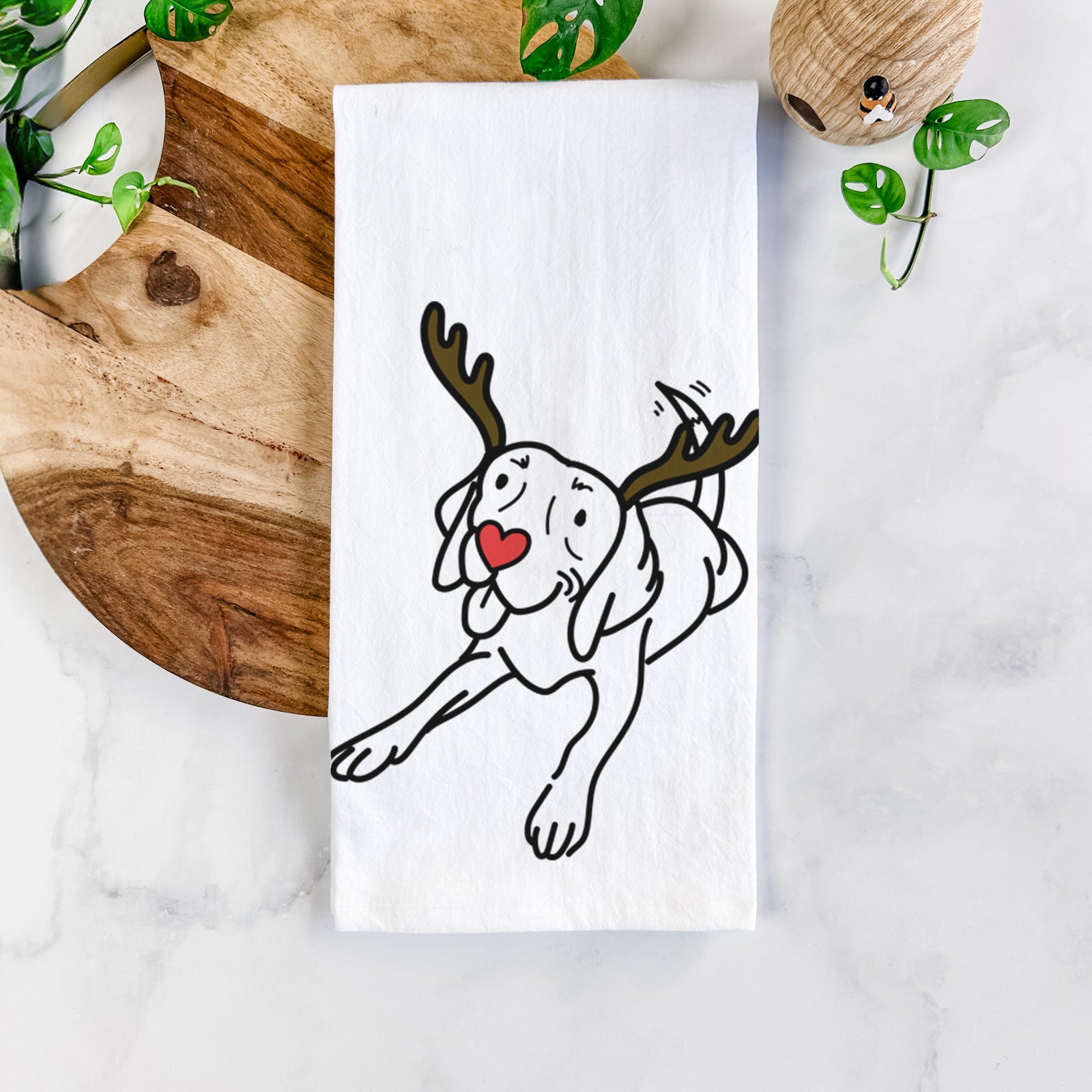 Minimalist line drawing of Bagel the Beagle with reindeer antlers and a red nose on a tea towel