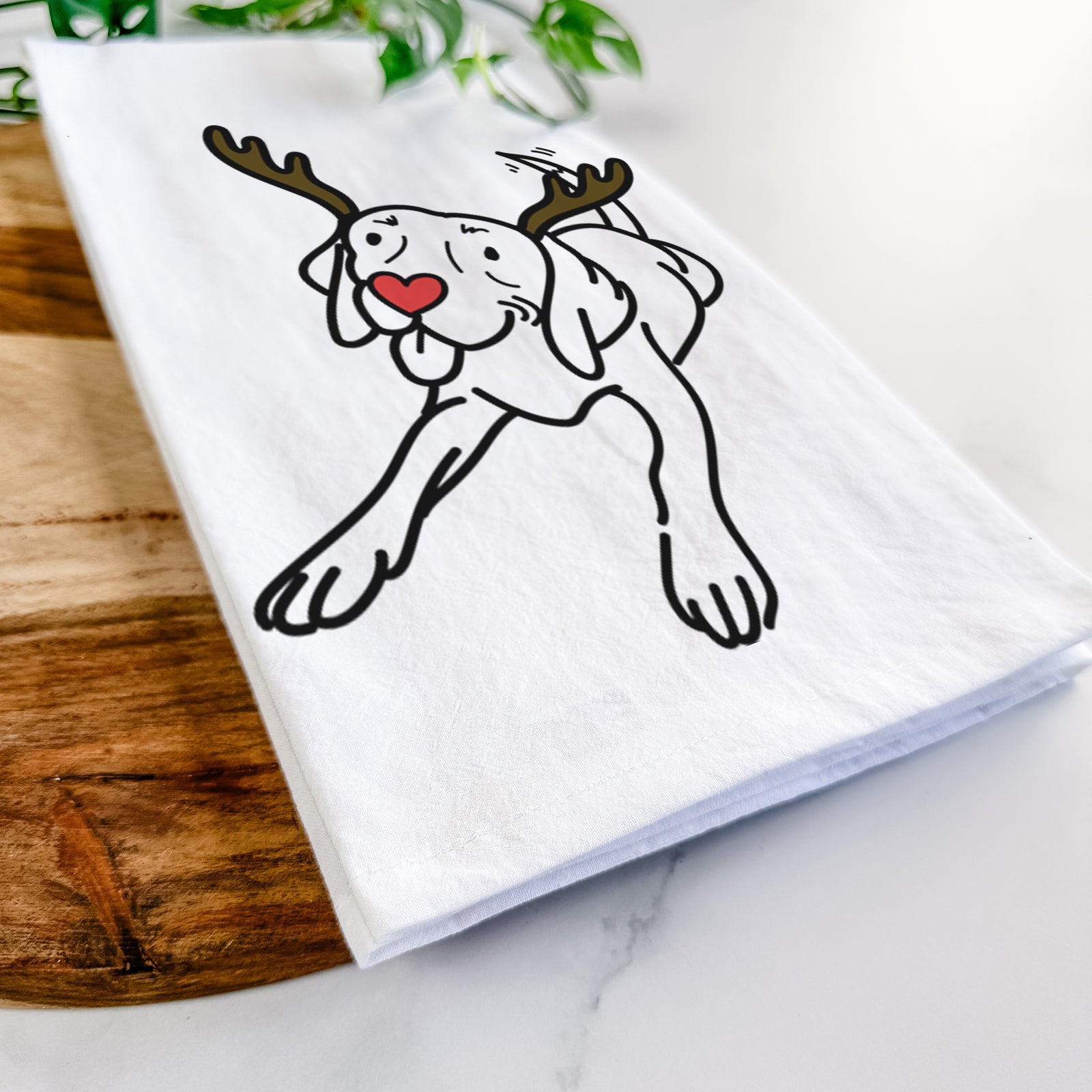 Minimalist line drawing of Bagel the Beagle with reindeer antlers and a red nose on a tea towel