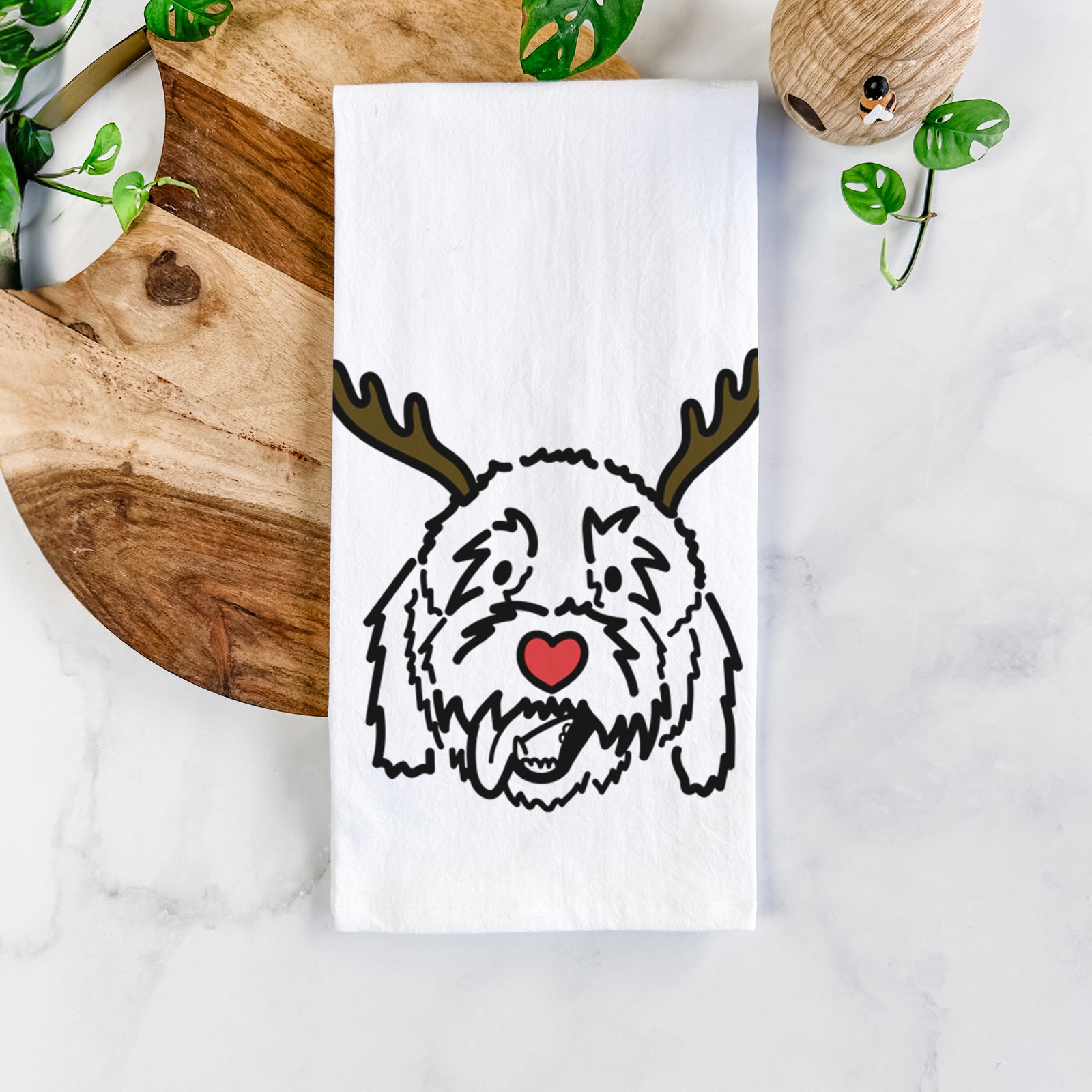 Minimalist line drawing of Barry the Goldendoodle with reindeer antlers and a red nose on a tea towel