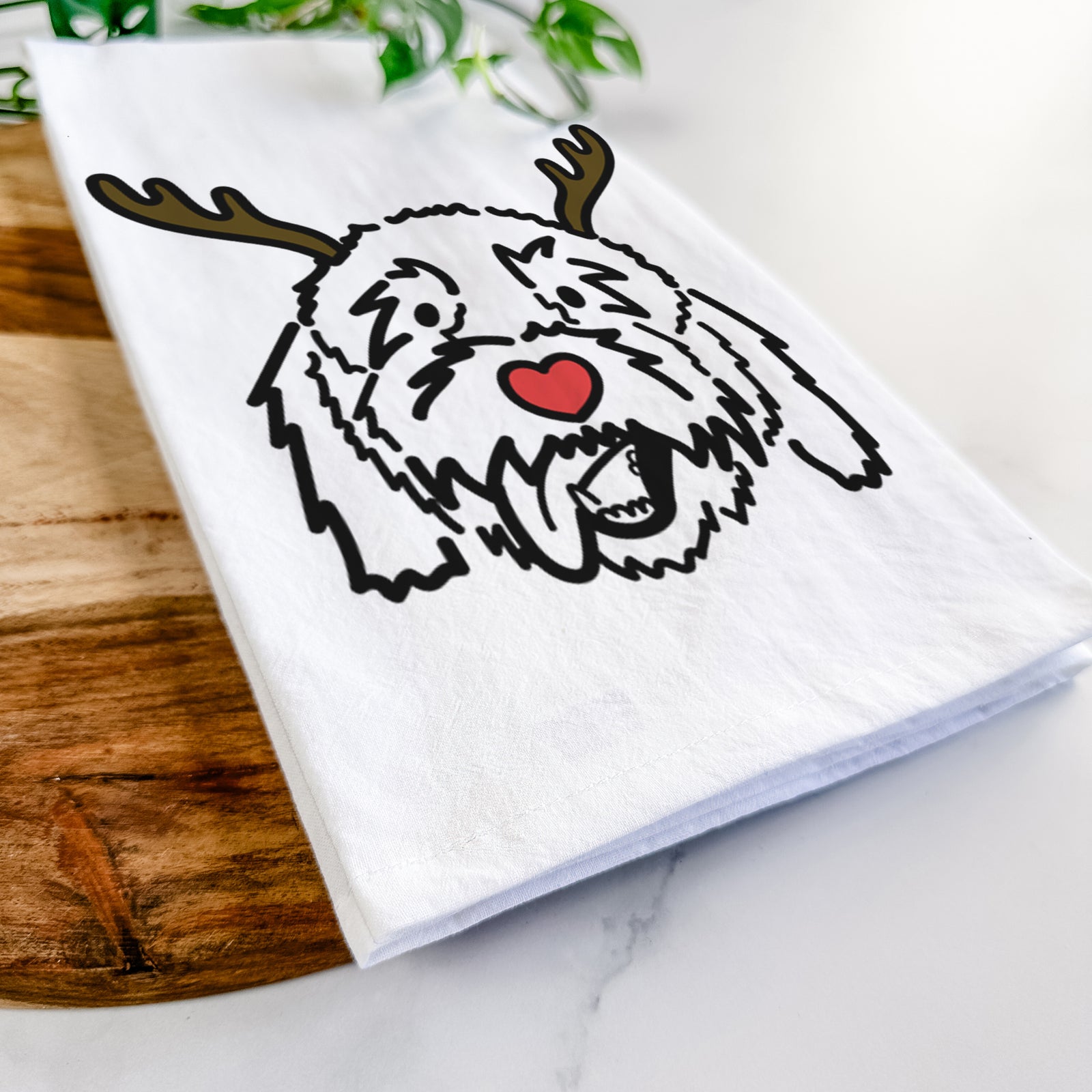 Minimalist line drawing of Barry the Goldendoodle with reindeer antlers and a red nose on a tea towel