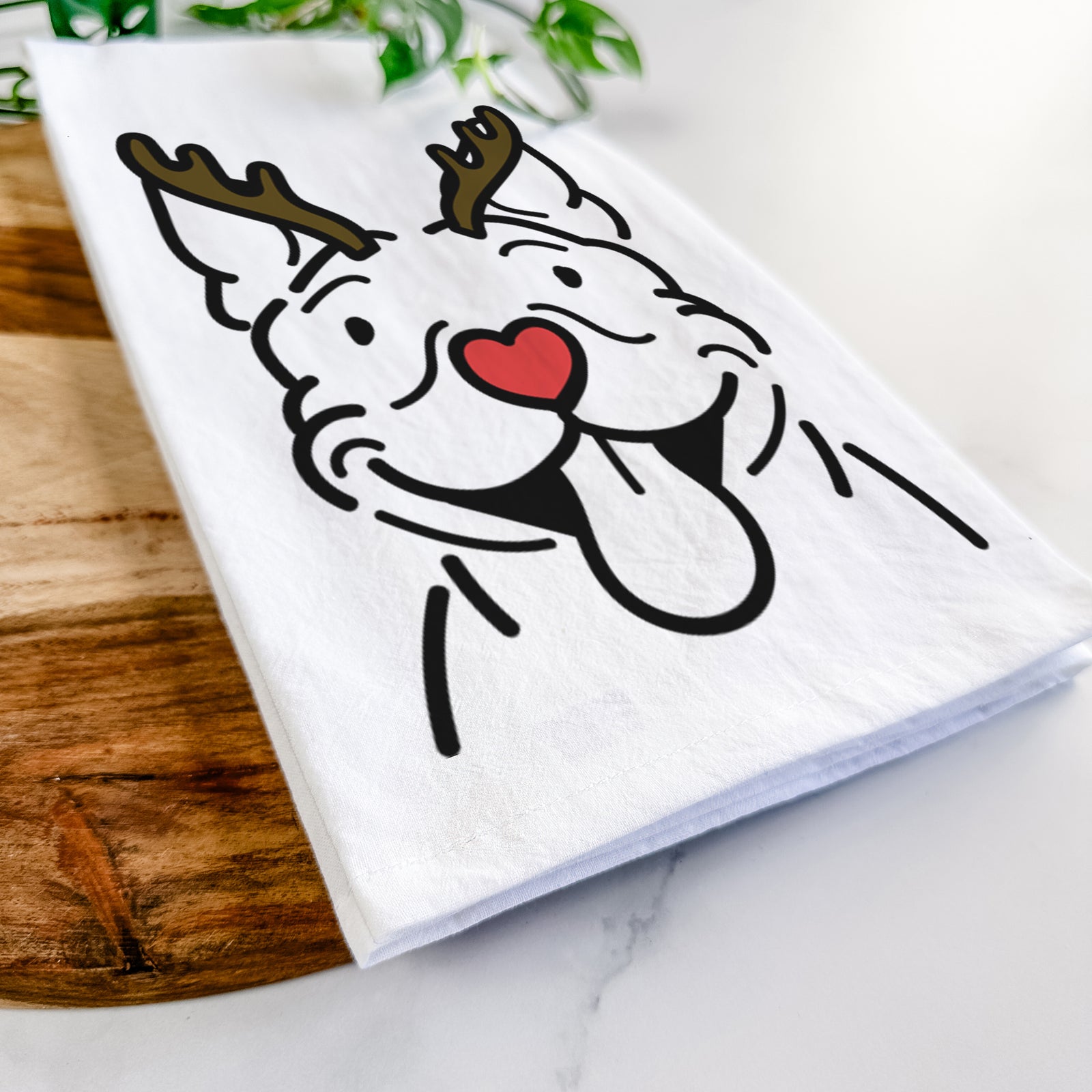Minimalist line drawing of Basil the Pitbull with reindeer antlers and a red nose on a tea towel