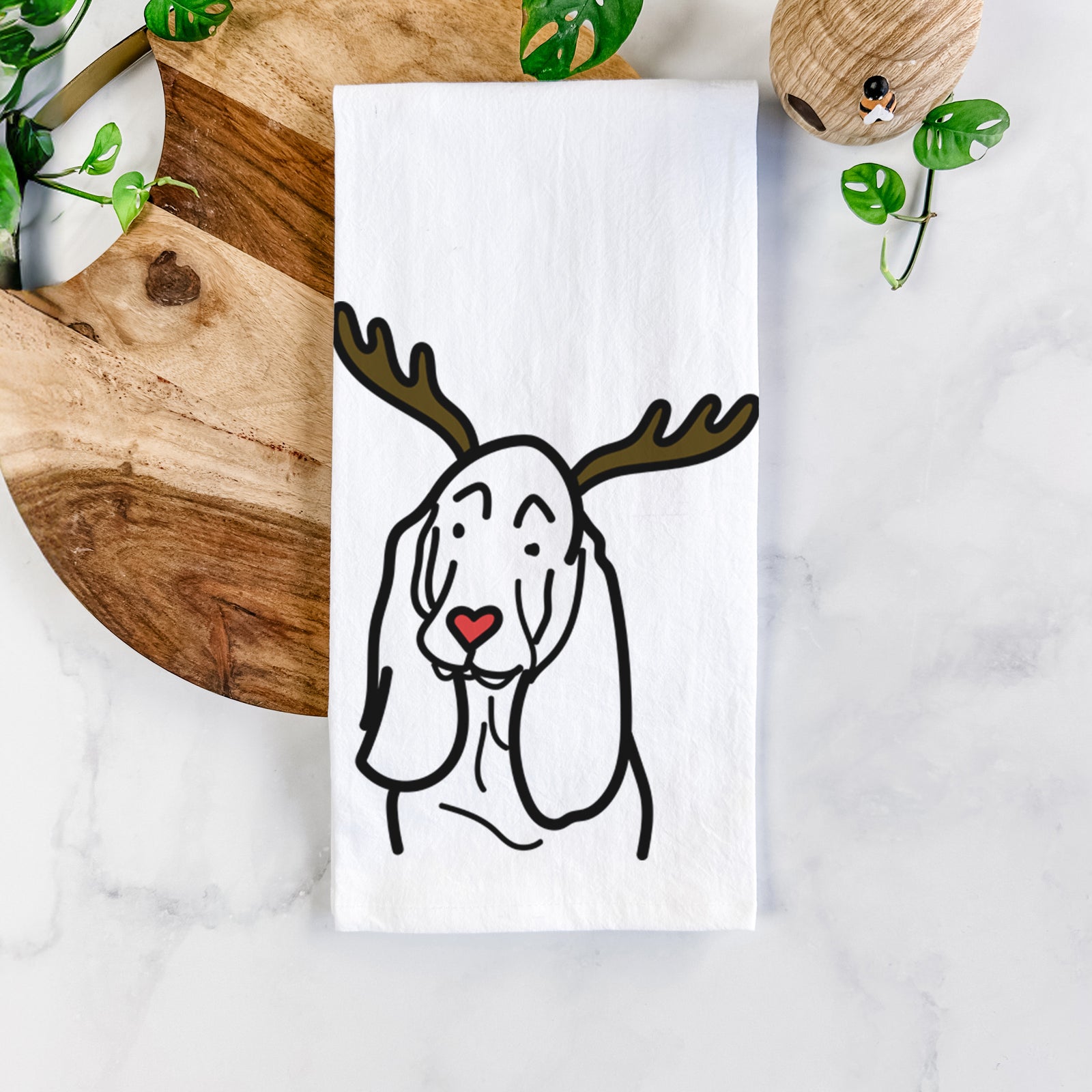 Minimalist line drawing of a Basset Hound with reindeer antlers and a red nose on a tea towel