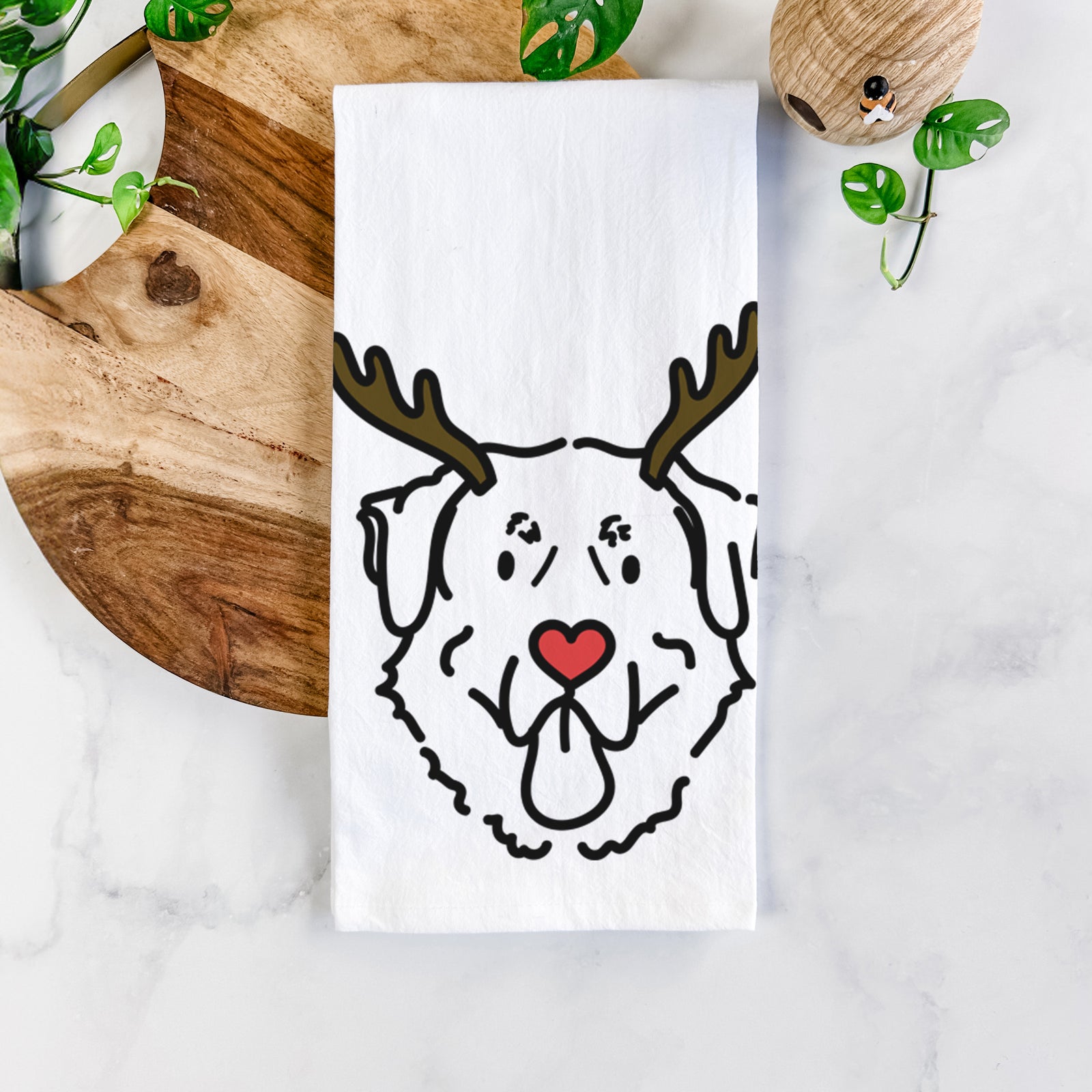Minimalist line drawing of Batu the Anatolian Shepherd with reindeer antlers and a red nose on a tea towel