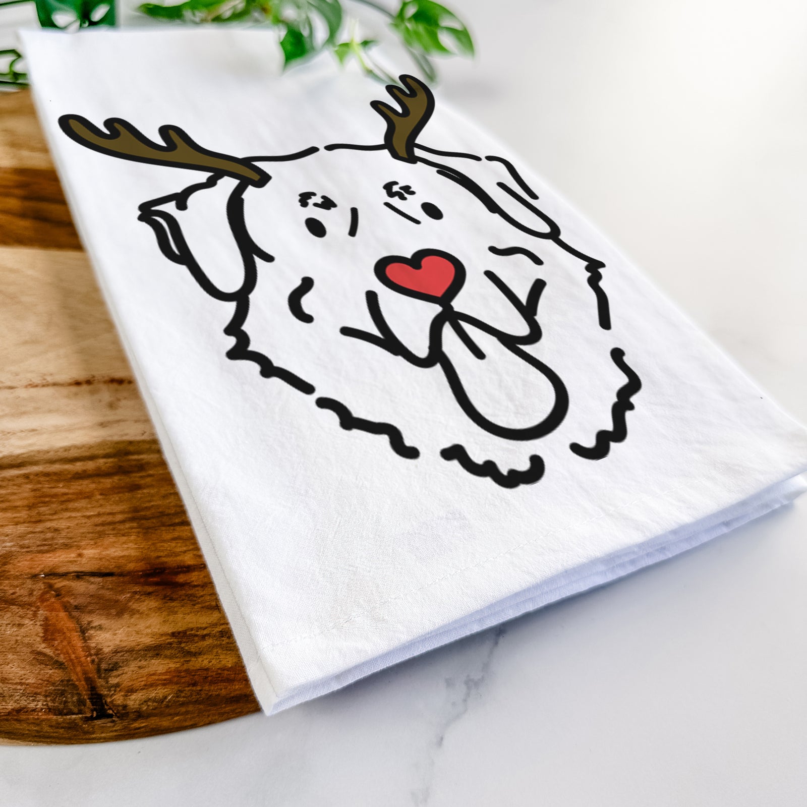 Minimalist line drawing of Batu the Anatolian Shepherd with reindeer antlers and a red nose on a tea towel