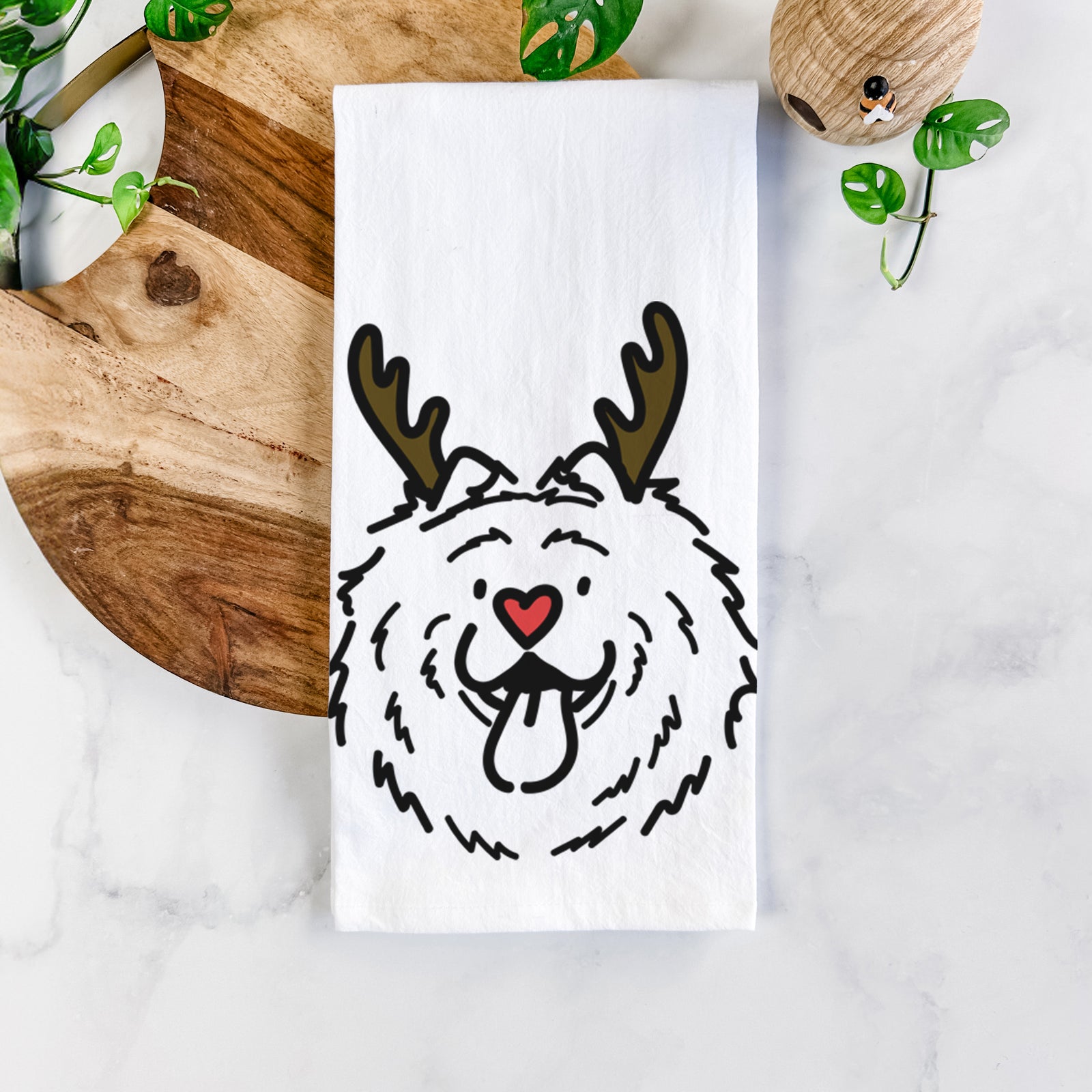 Minimalist line drawing of Bear the Chow Chow with reindeer antlers and a red nose on a tea towel