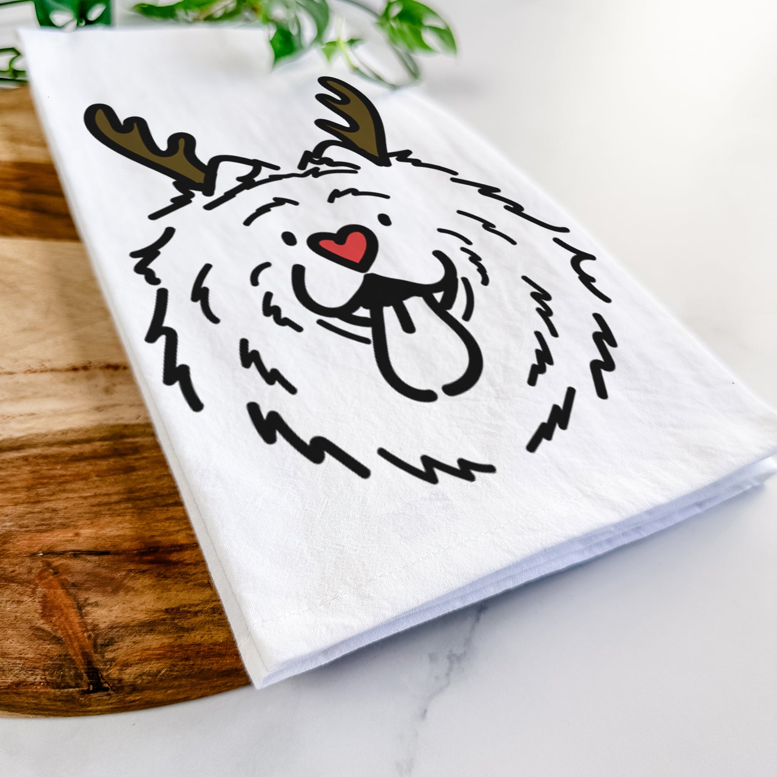 Minimalist line drawing of Bear the Chow Chow with reindeer antlers and a red nose on a tea towel
