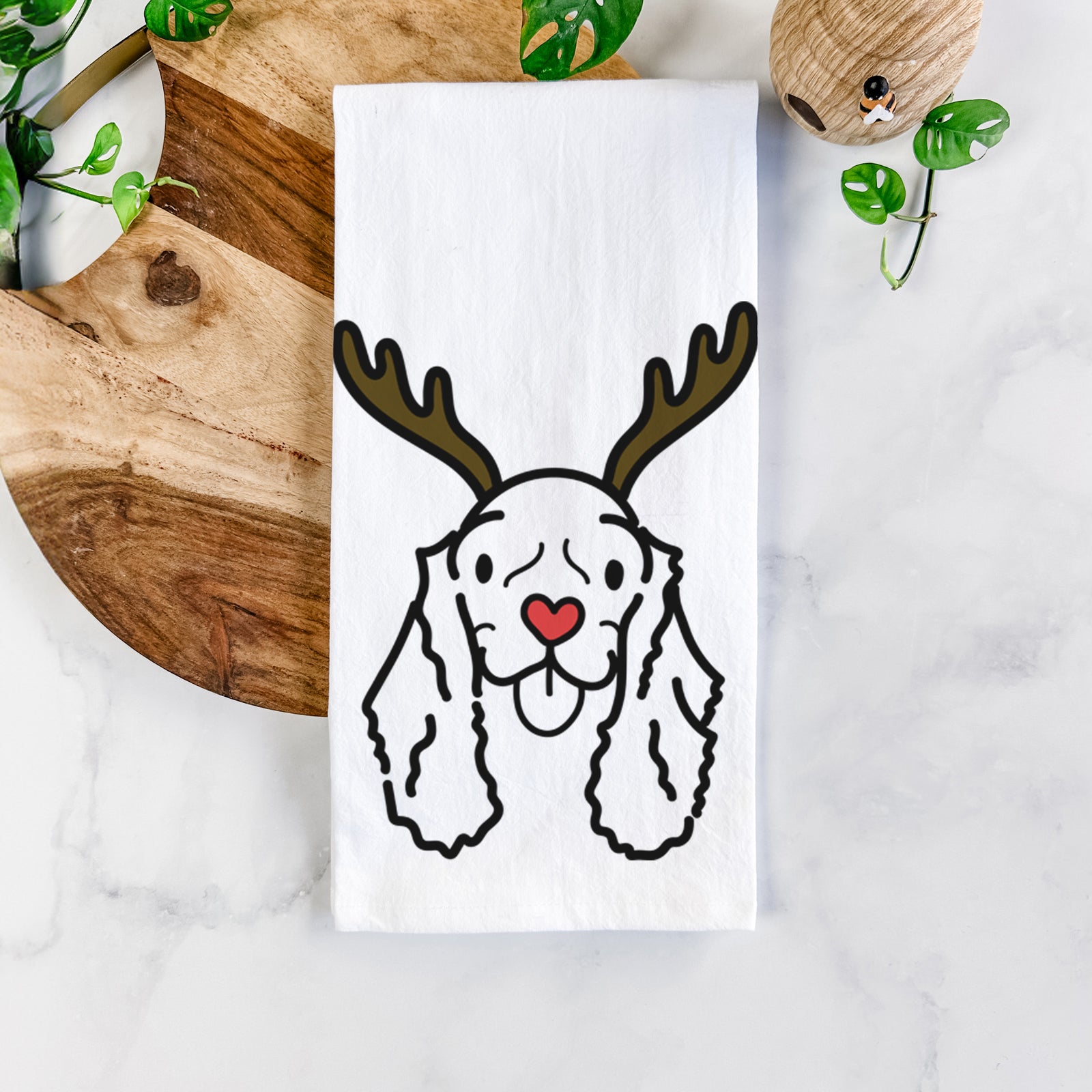 Minimalist line drawing of Bella the American Cocker Spaniel with reindeer antlers and a red nose on a tea towel
