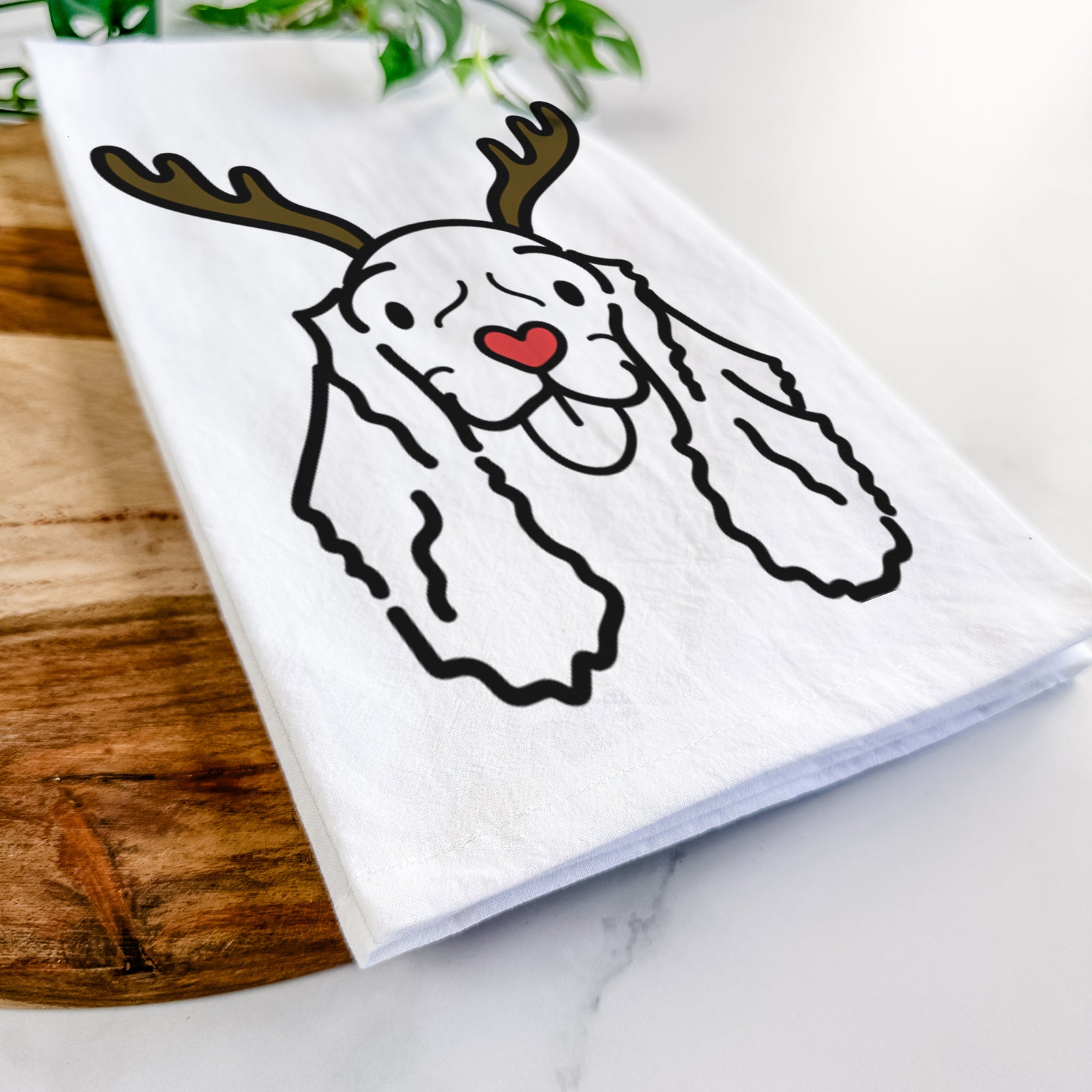 Minimalist line drawing of Bella the American Cocker Spaniel with reindeer antlers and a red nose on a tea towel