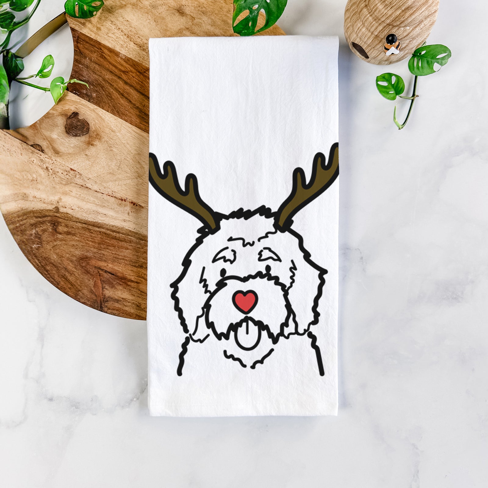 Minimalist line drawing of a Bernedoodle with reindeer antlers and a red nose on a tea towel