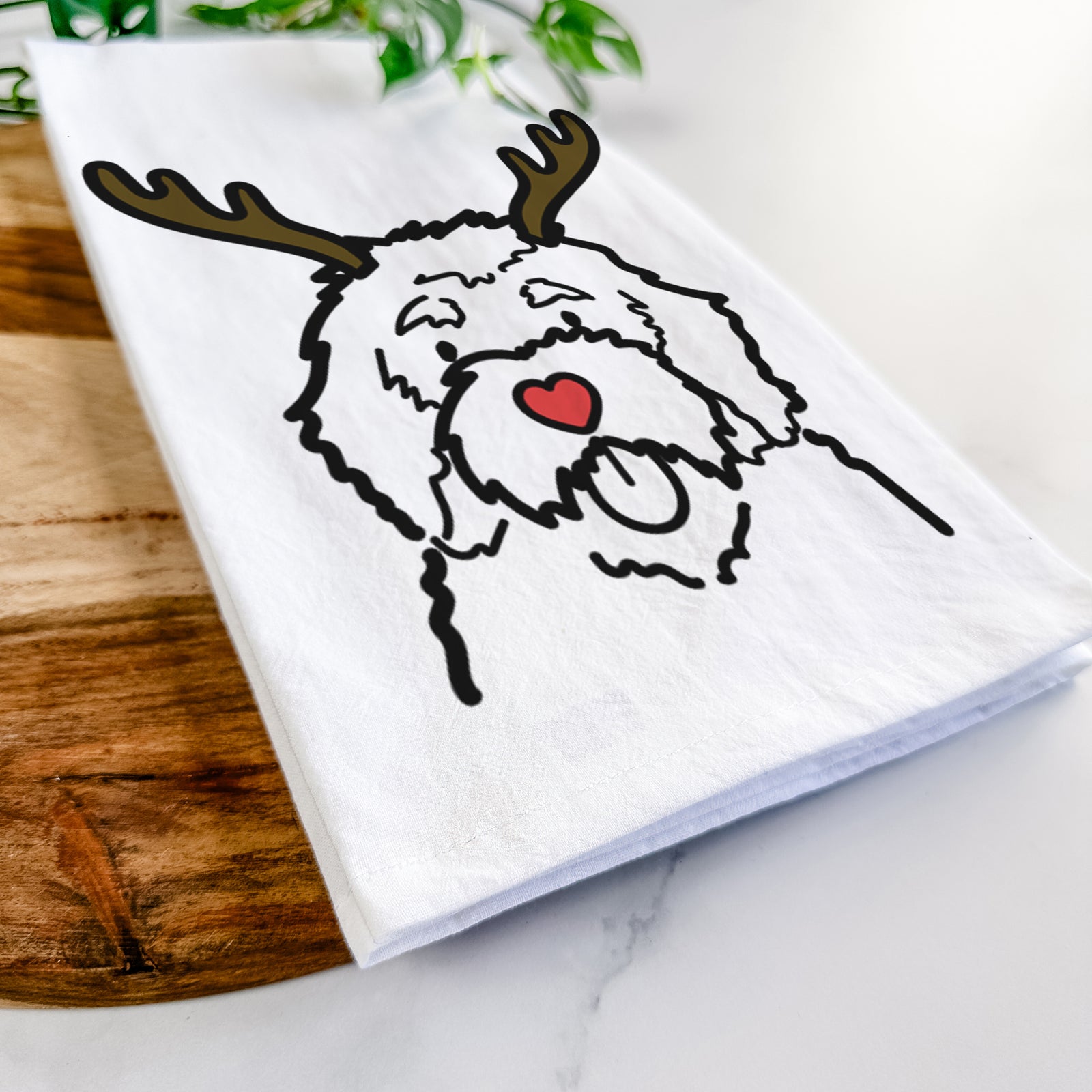 Minimalist line drawing of a Bernedoodle with reindeer antlers and a red nose on a tea towel