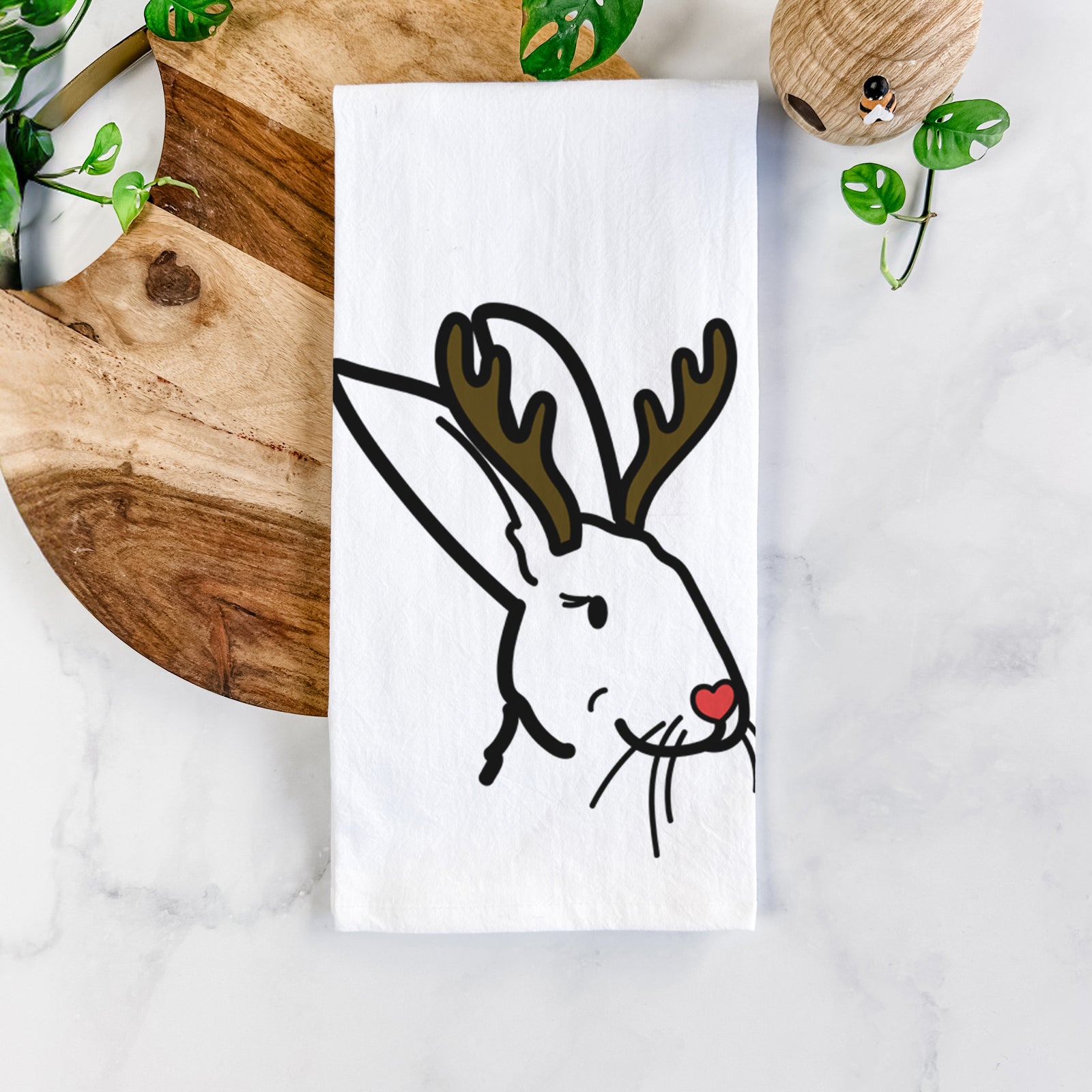 Minimalist line drawing of Betsy the Rex Rabbit with reindeer antlers and a red nose on a tea towel