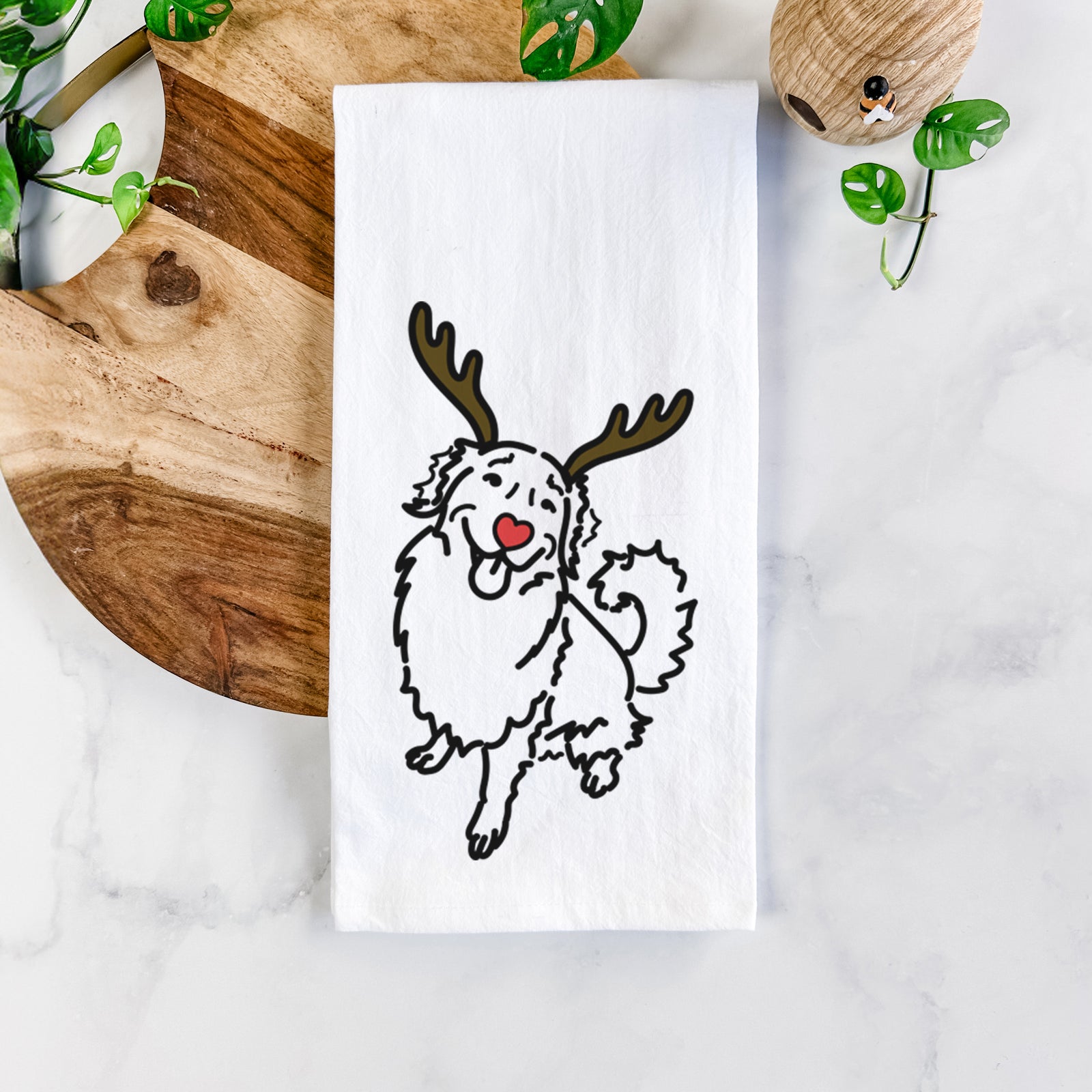 Minimalist line drawing of Brinkley the Golden Retriever with reindeer antlers and a red nose on a tea towel
