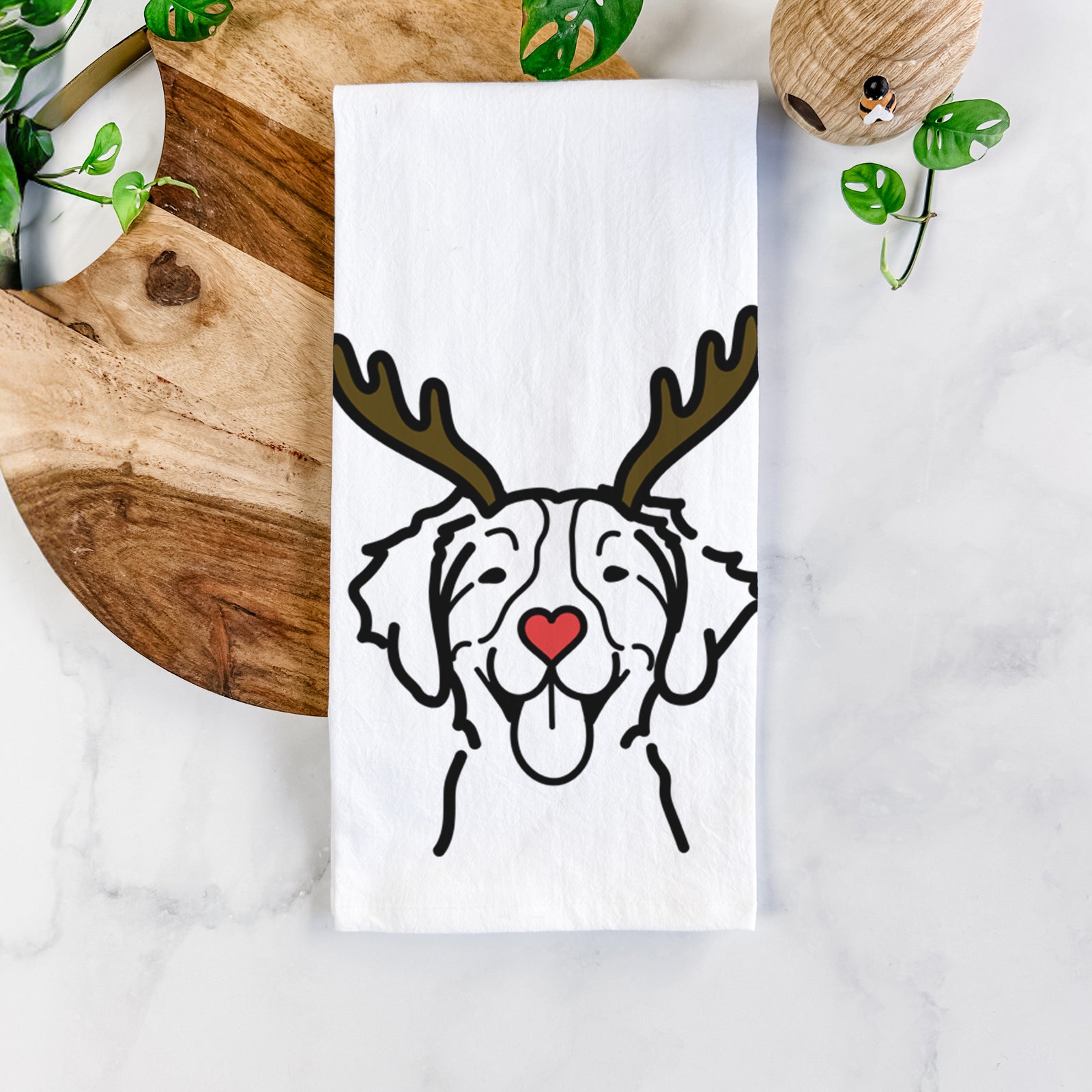 Minimalist line drawing of a Brittany with reindeer antlers and a red nose on a tea towel