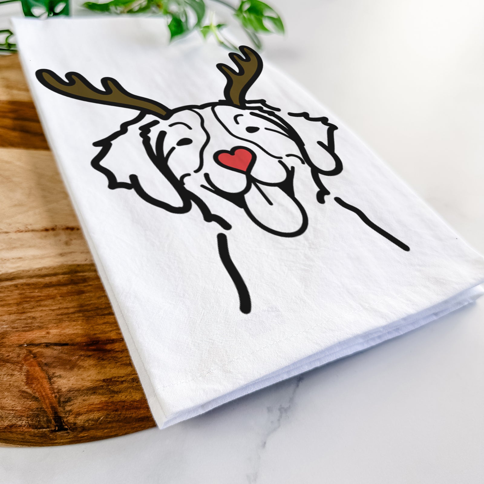 Minimalist line drawing of a Brittany with reindeer antlers and a red nose on a tea towel
