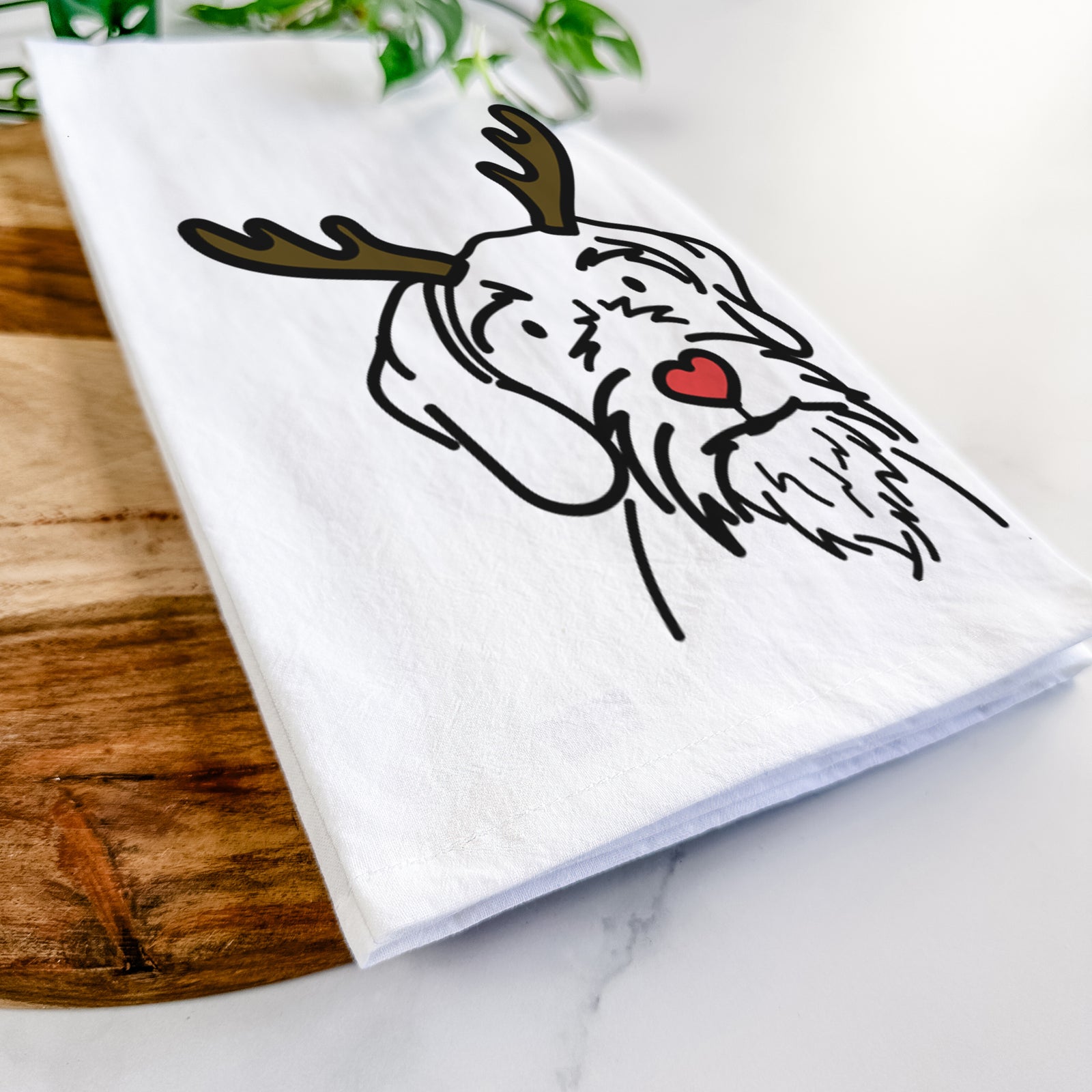 Minimalist line drawing of Buck the German Wirehaired Pointer with reindeer antlers and a red nose on a tea towel