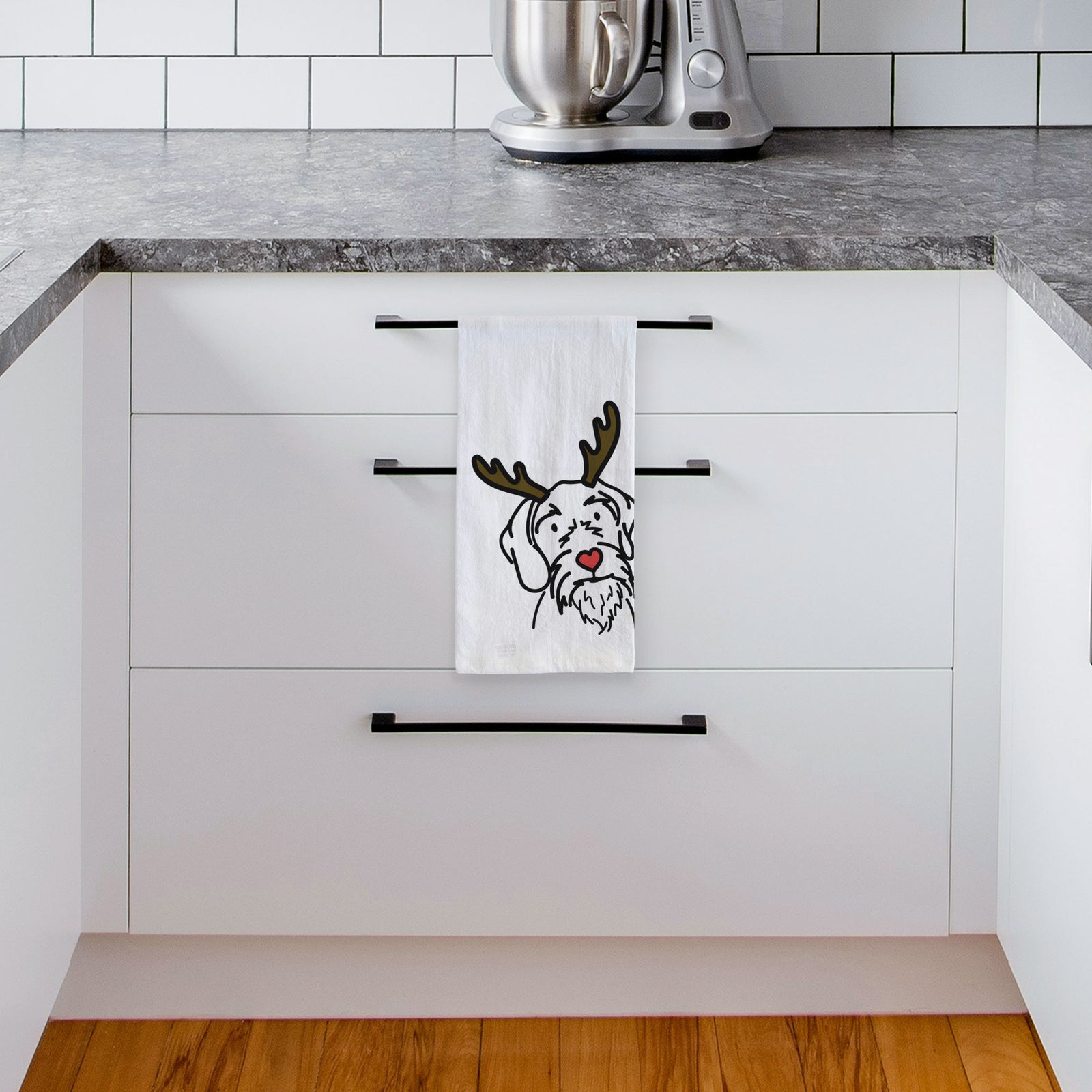 Minimalist line drawing of Buck the German Wirehaired Pointer with reindeer antlers and a red nose on a tea towel, hanging on an oven door in a kitchen