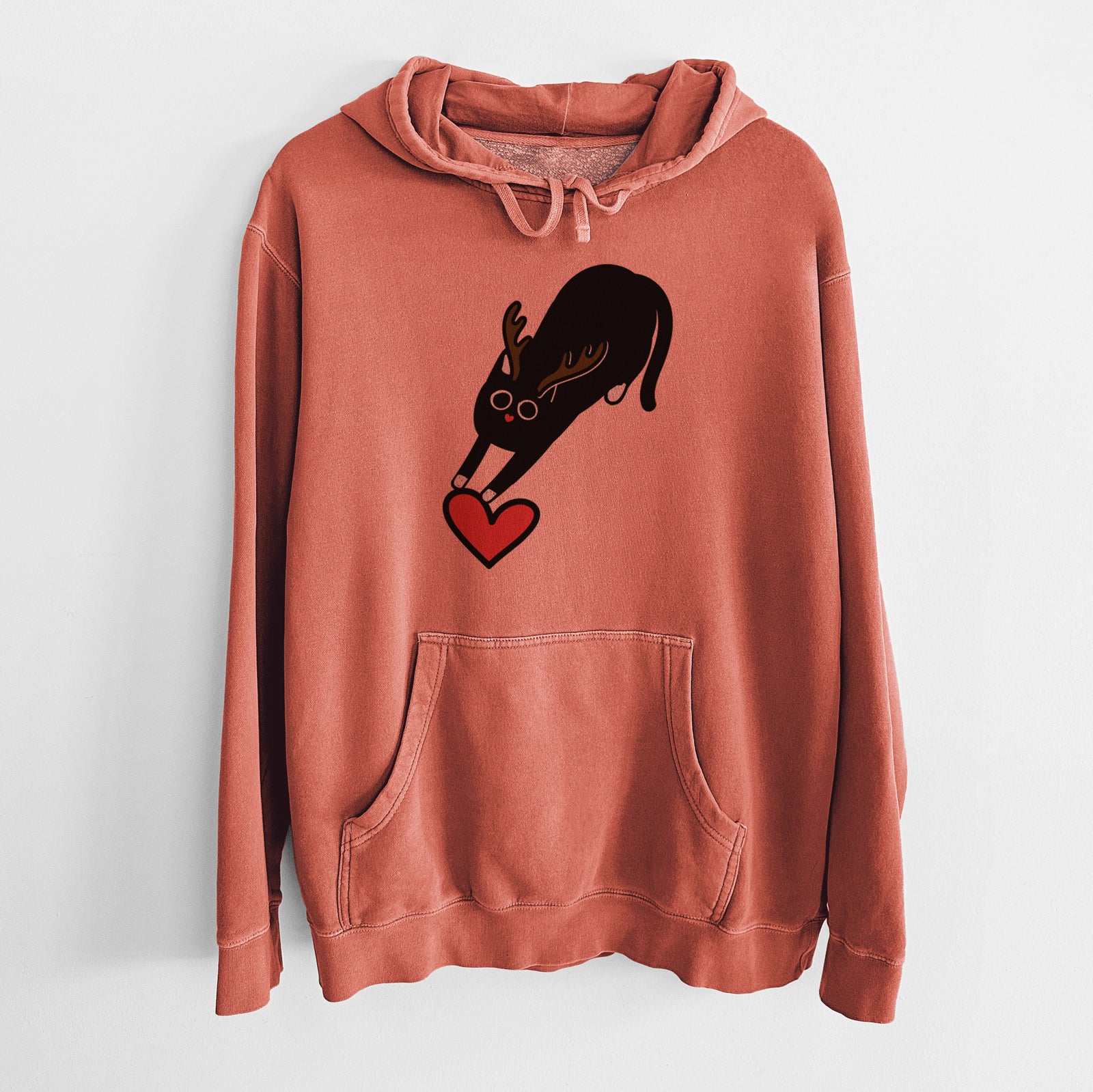 Minimalist line drawing of Bug the Black Cat with reindeer antlers and a red nose on an Amber Unisex pigment dyed hoodie