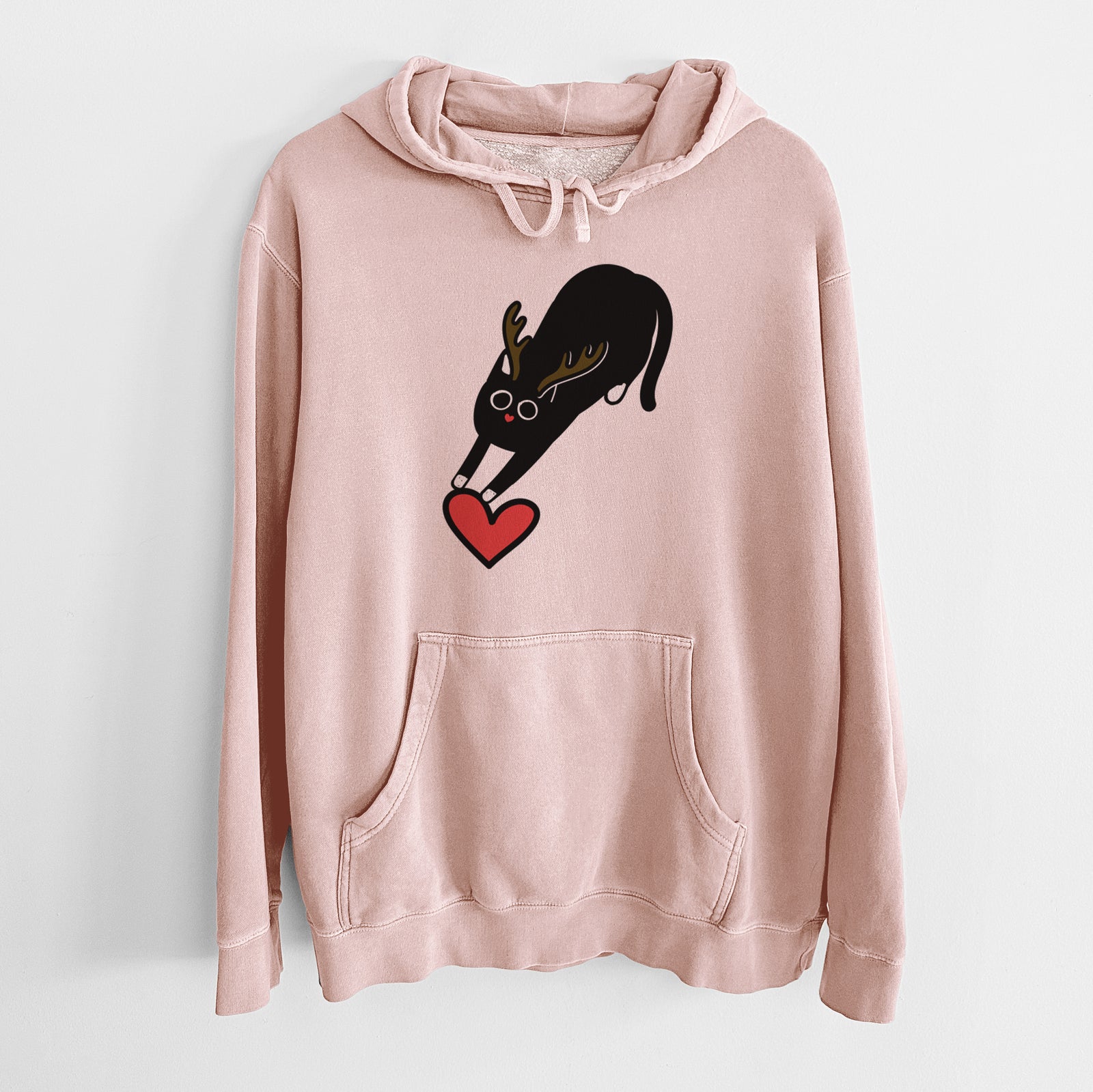 Minimalist line drawing of Bug the Black Cat with reindeer antlers and a red nose on a Dusty Pink Unisex pigment dyed hoodie