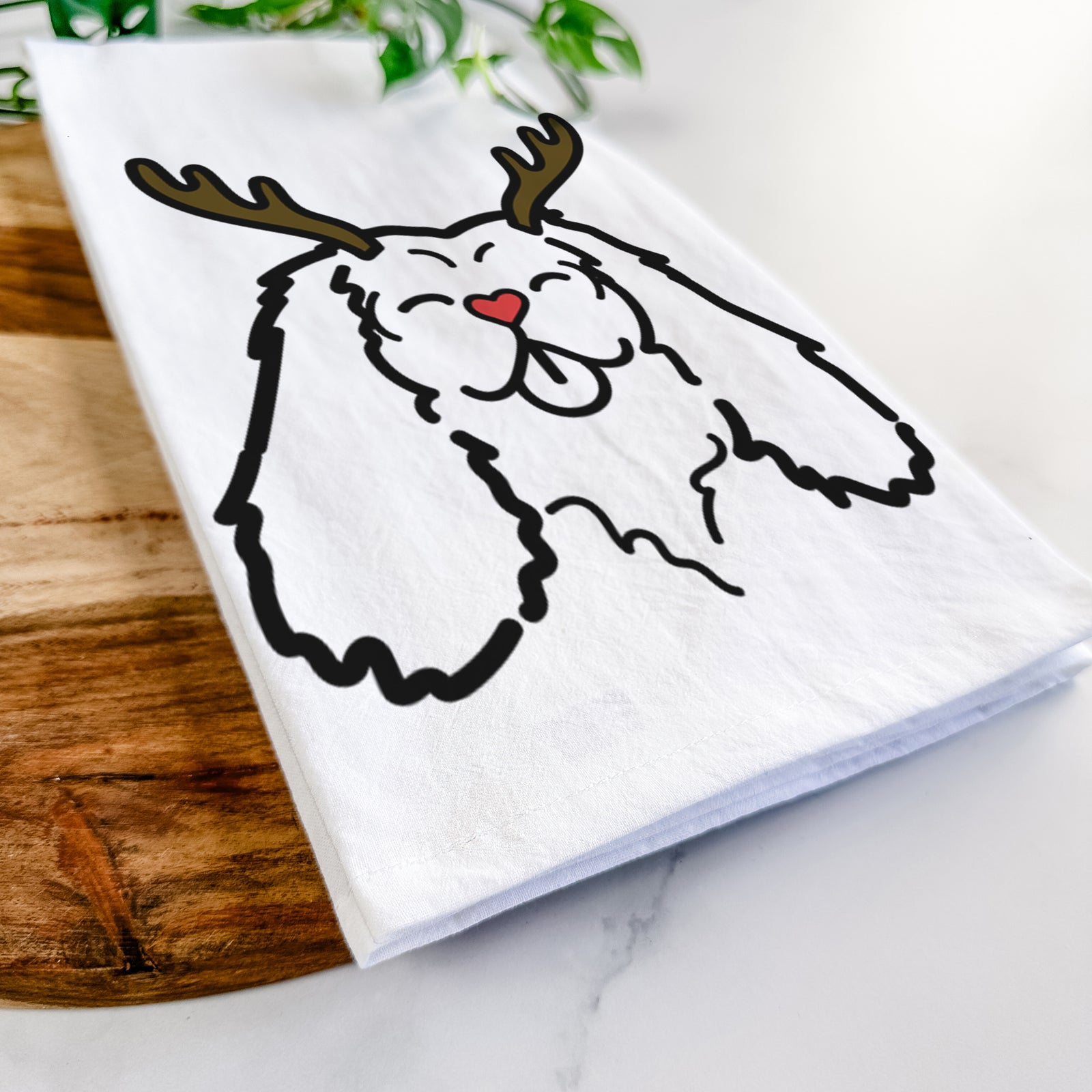 Minimalist line drawing of a Cavalier King Charles Spaniel with reindeer antlers and a red nose on a tea towel