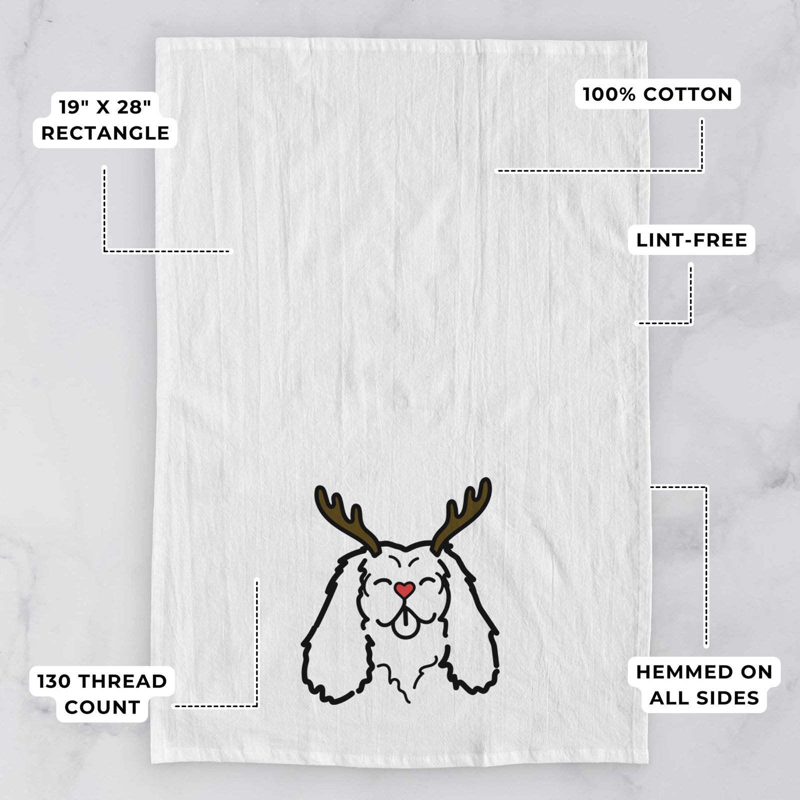 Minimalist line drawing of a Cavalier King Charles Spaniel with reindeer antlers and a red nose on a tea towel, with feature callouts: 19 x 28 inch rectangle, 100% cotton, lint-free, 120 thread count, hemmed on all sides
