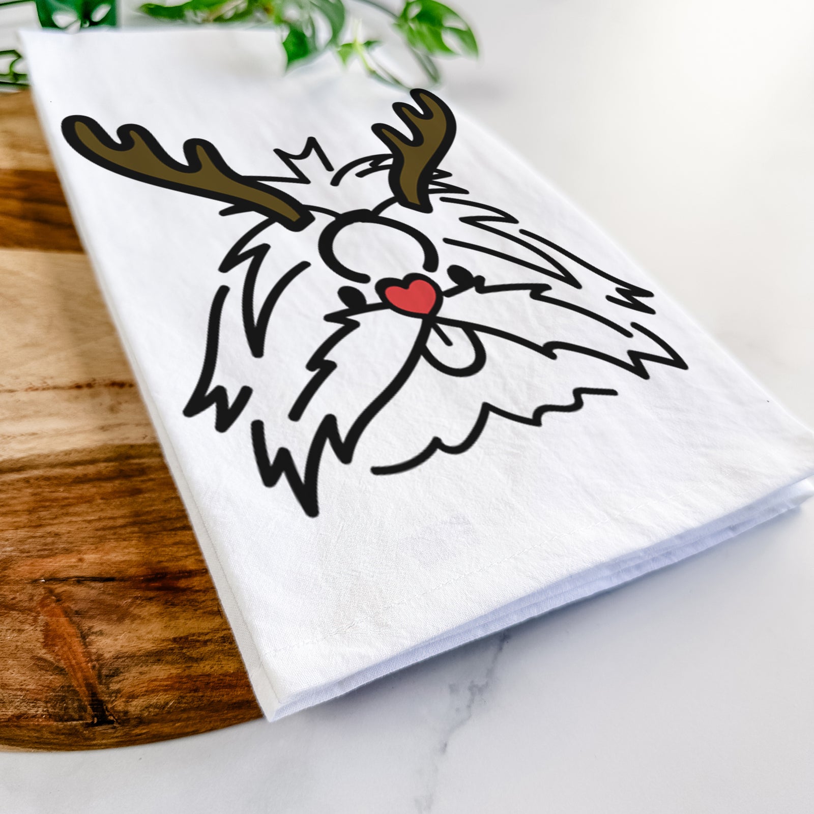 Minimalist line drawing of CoCo the Shih Tzu with reindeer antlers and a red nose on a tea towel