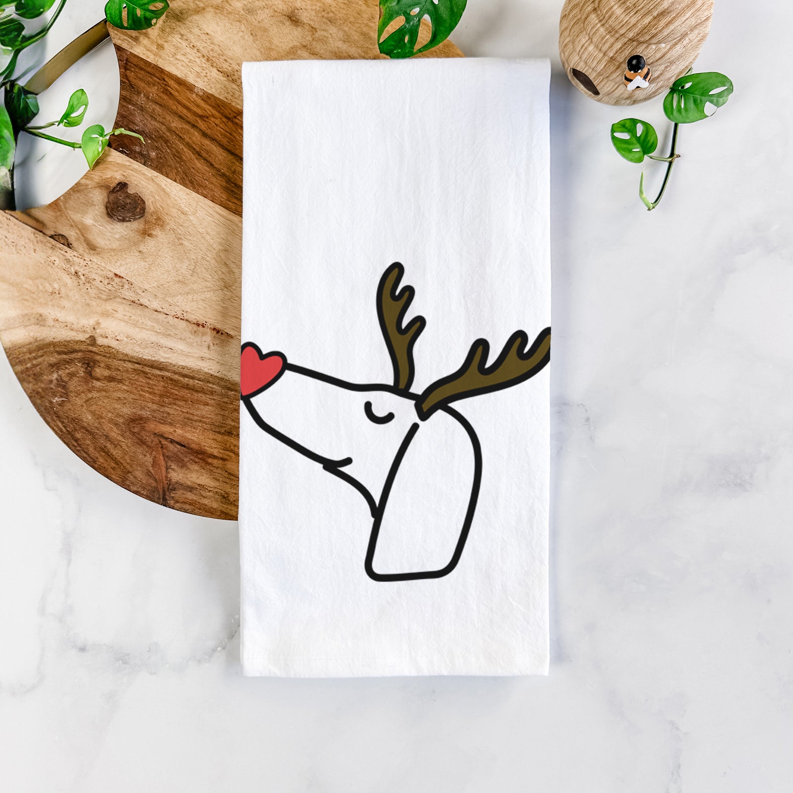 Minimalist line drawing of a Dachshund with reindeer antlers and a red nose on a tea towel