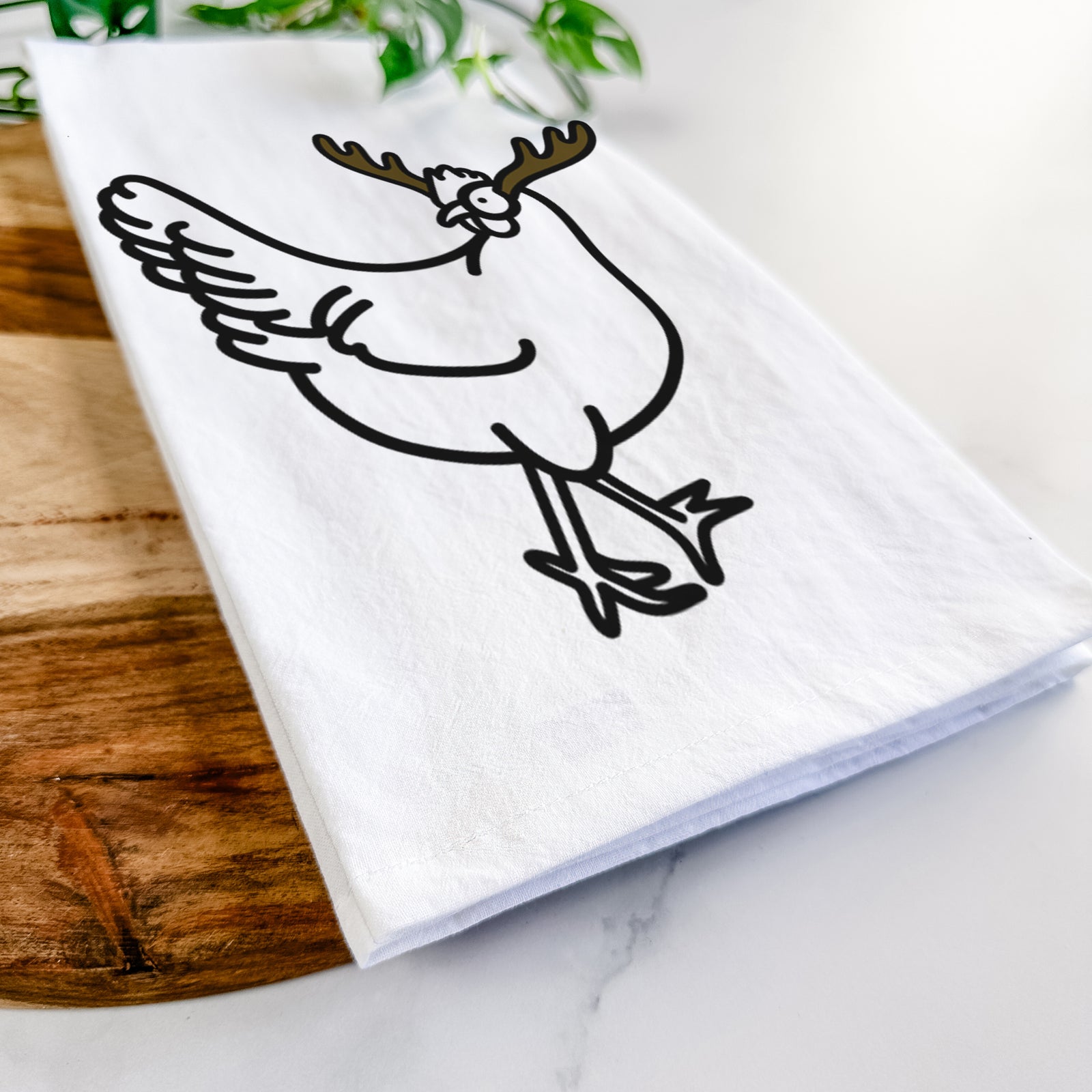 Minimalist line drawing of Daisy the Chicken with reindeer antlers and a red nose on a tea towel