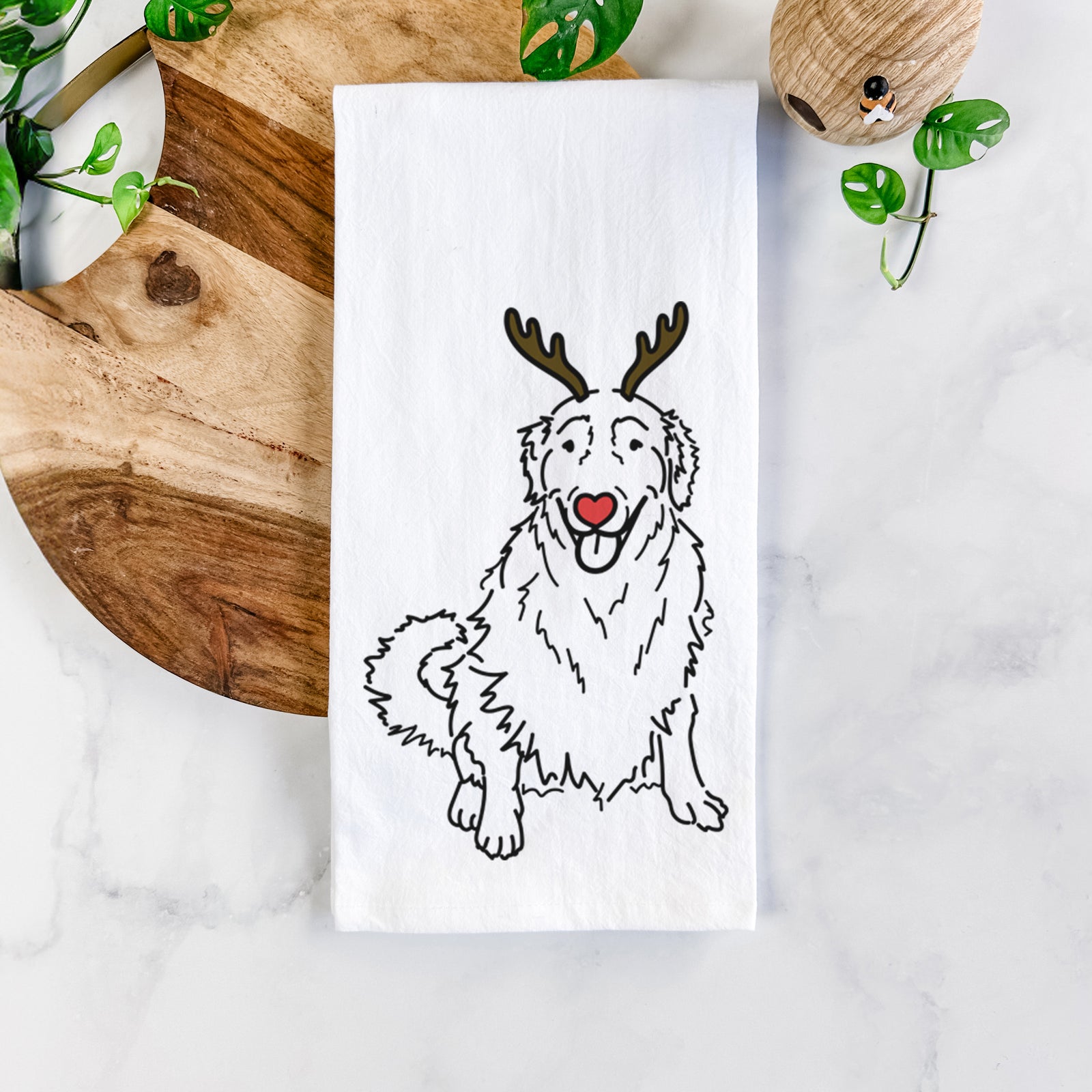 Minimalist line drawing of Daisy the Golden Retriever with reindeer antlers and a red nose on a tea towel
