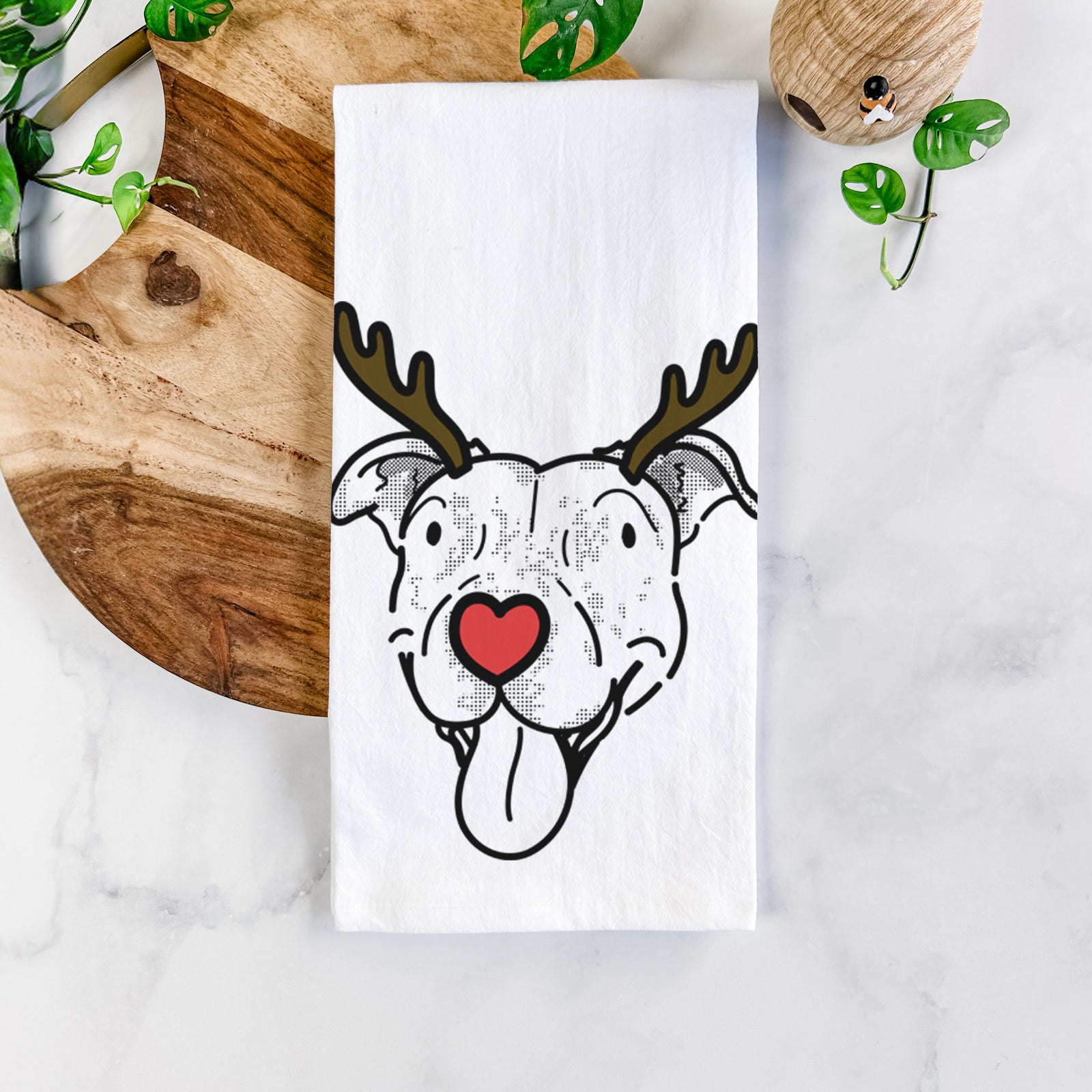 Minimalist line drawing of Dottie the Pitbull Mix with reindeer antlers and a red nose on a tea towel