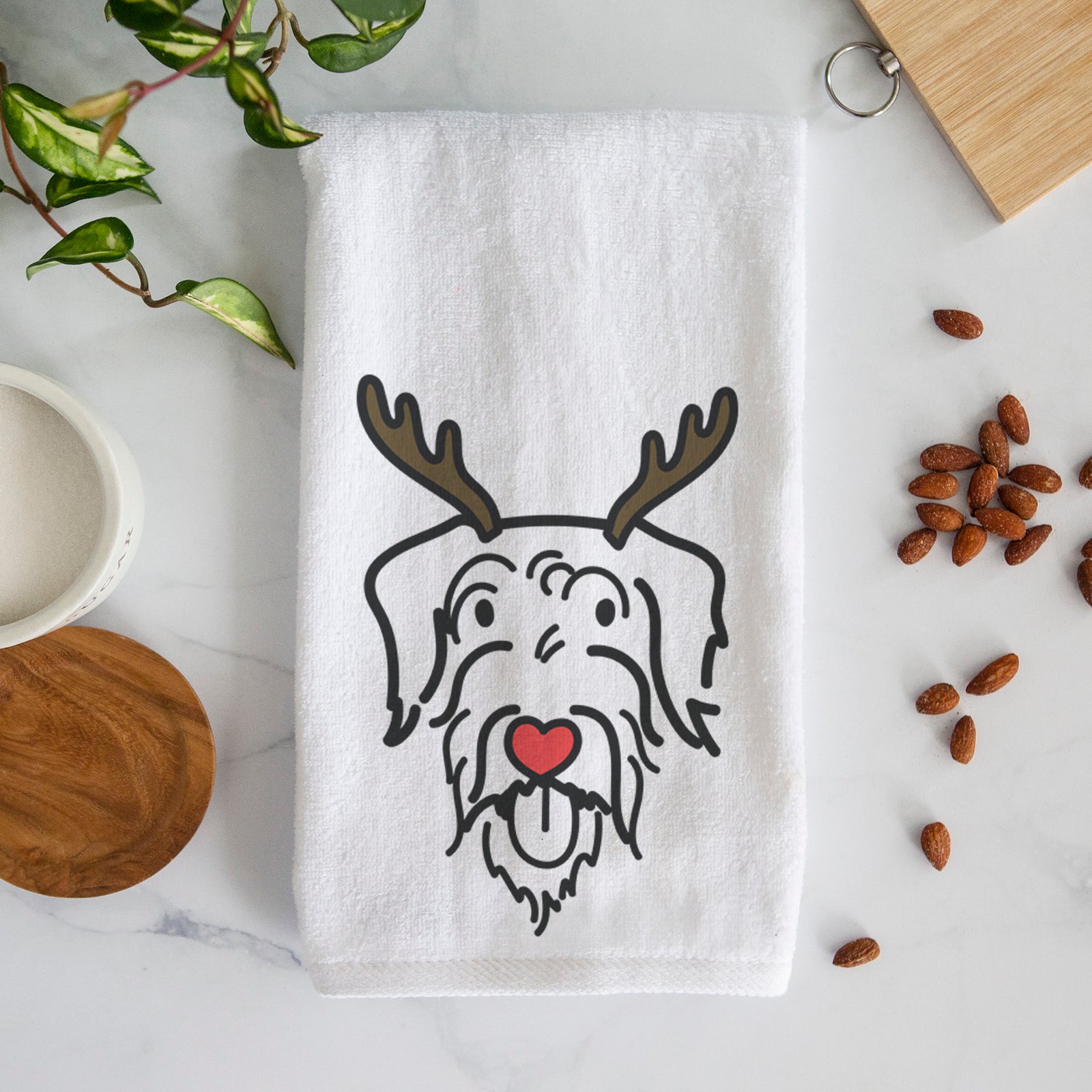 Minimalist line drawing of Dug the Doodle with reindeer antlers and a red nose on a decorative hand towel